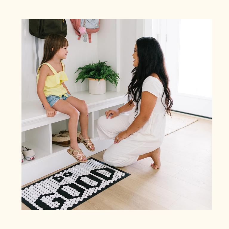 A tile mat being used inside someones home.