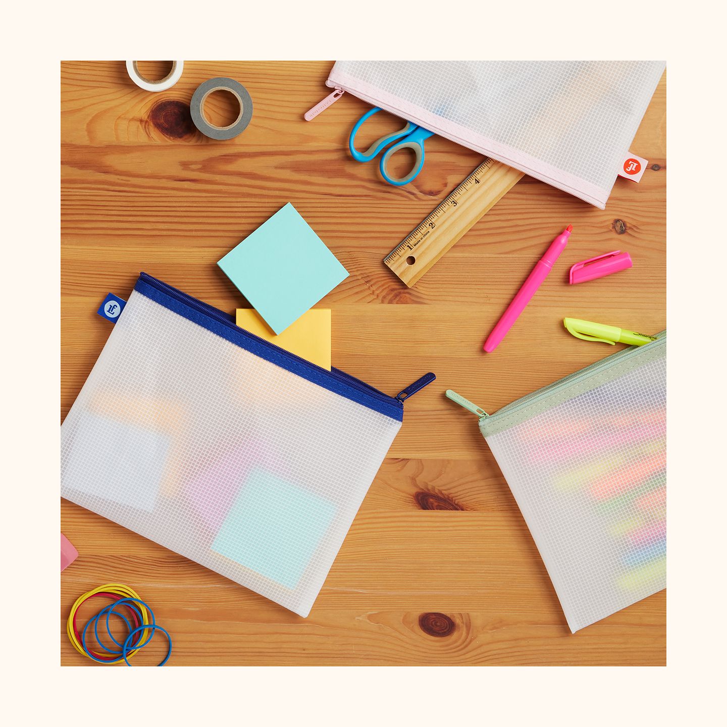 Blush, Sage, and Navy pouches containing various school supplies.