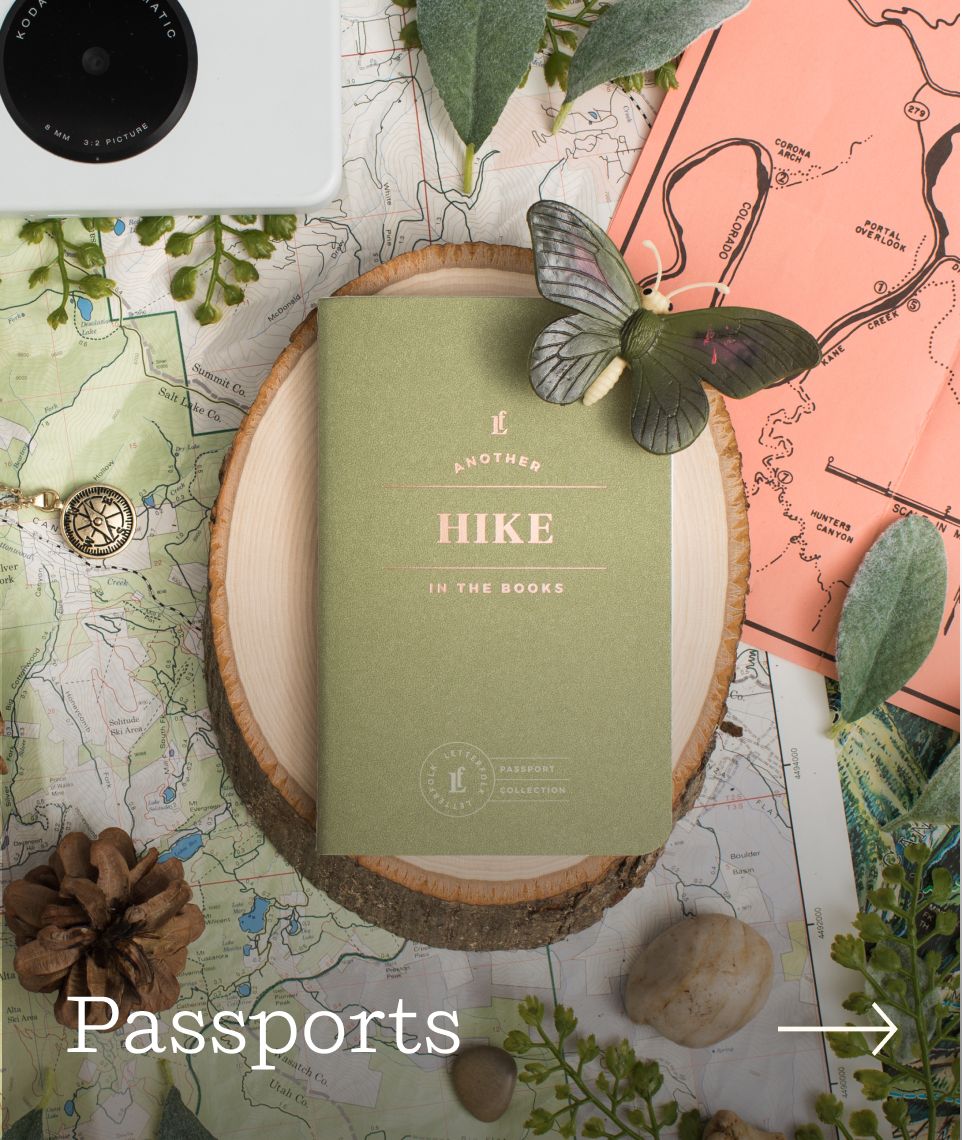 A Hike Passport with various objects around it.