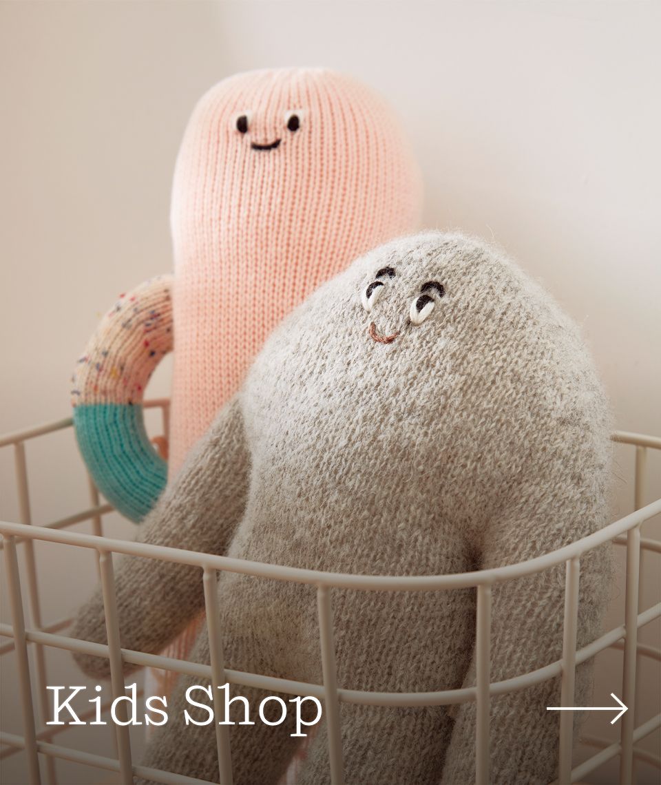 Two plush kids pillows inside a basket.