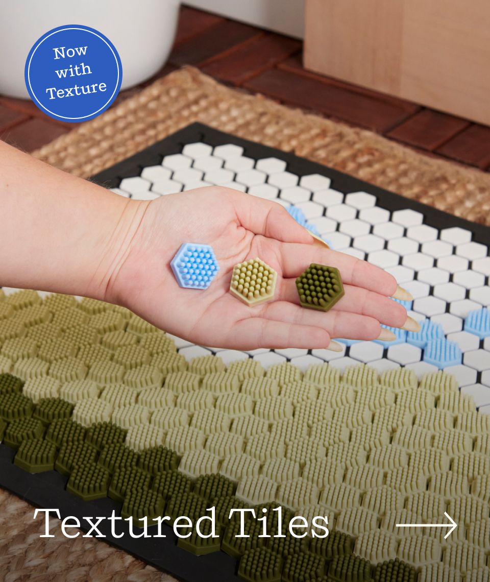 A hand showing the three different colors of textured tiles.