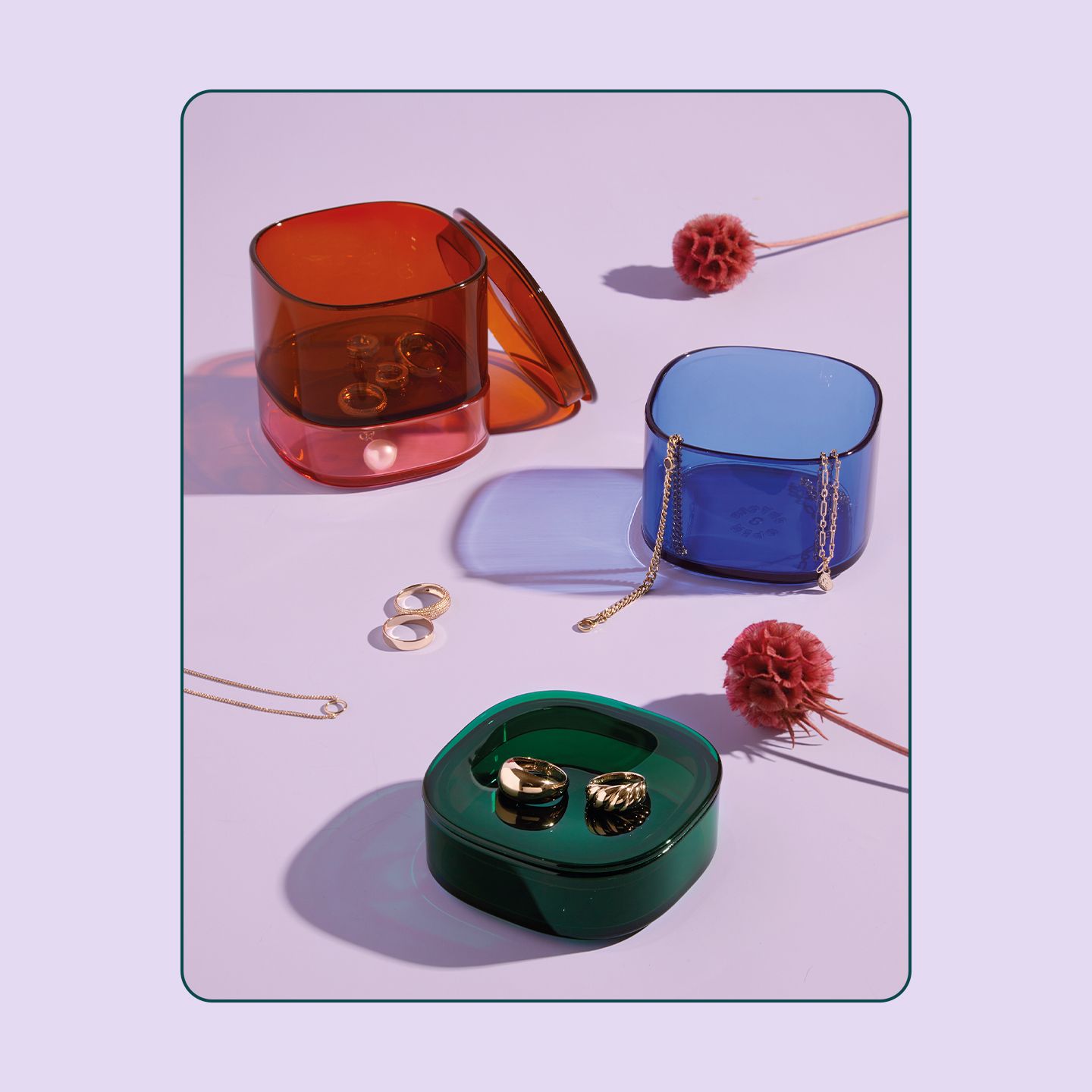 An image of the Open Spaces storage gems shot on a purple background with various small items outside of the units.