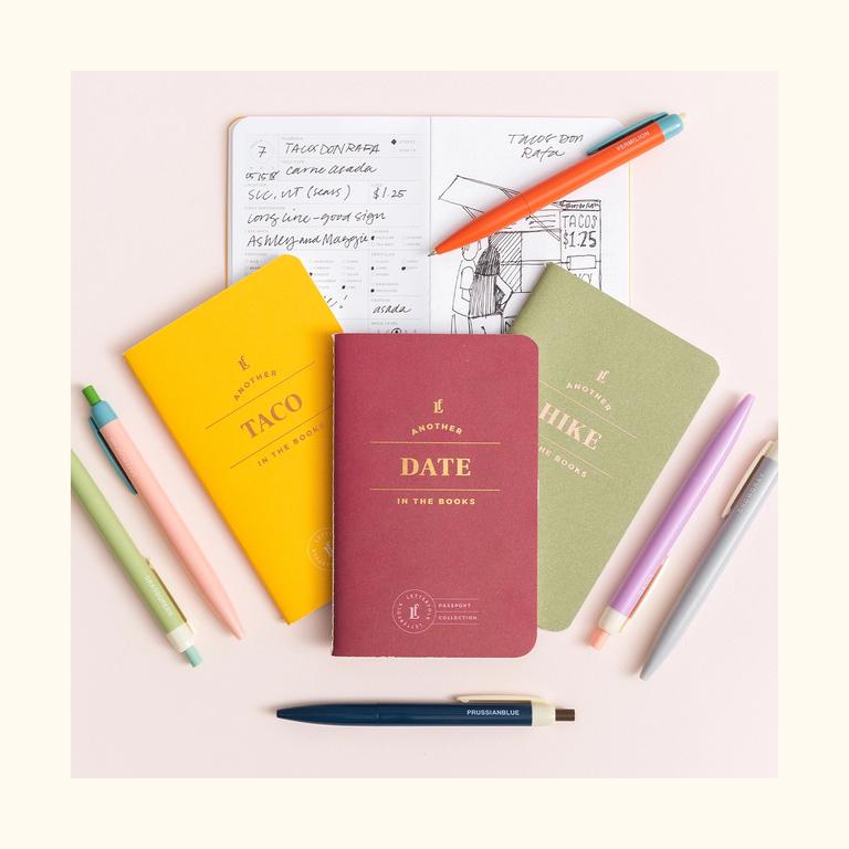 A group of three passports with pencils around.