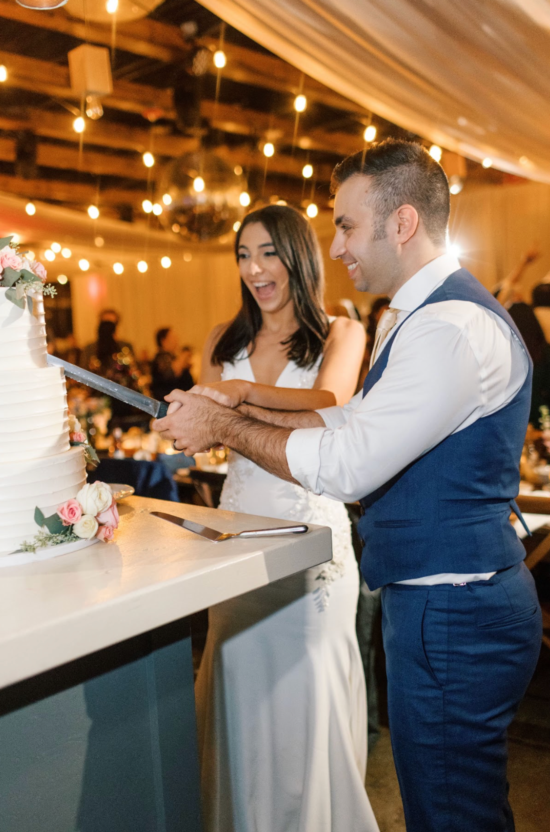 Photo of wedding couple cutting cake