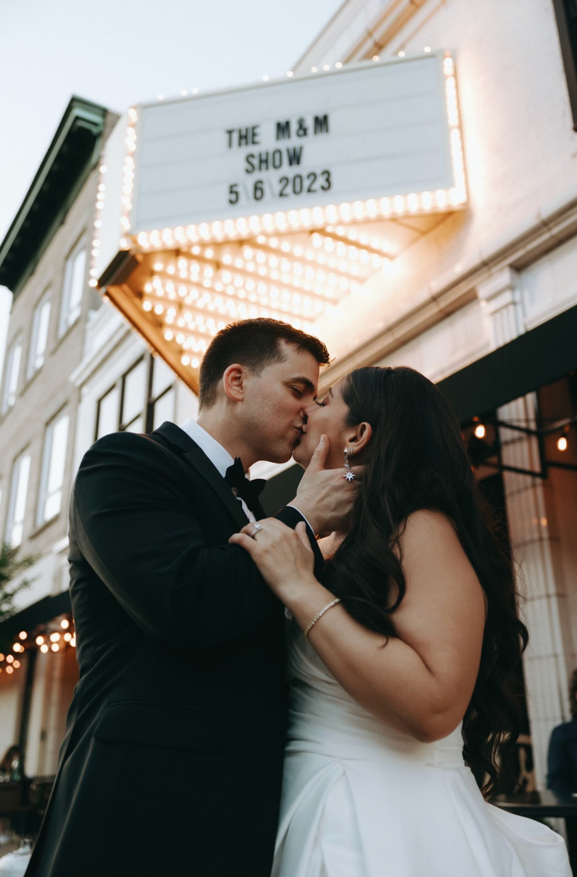 Photo of wedding couple under custom Marquee