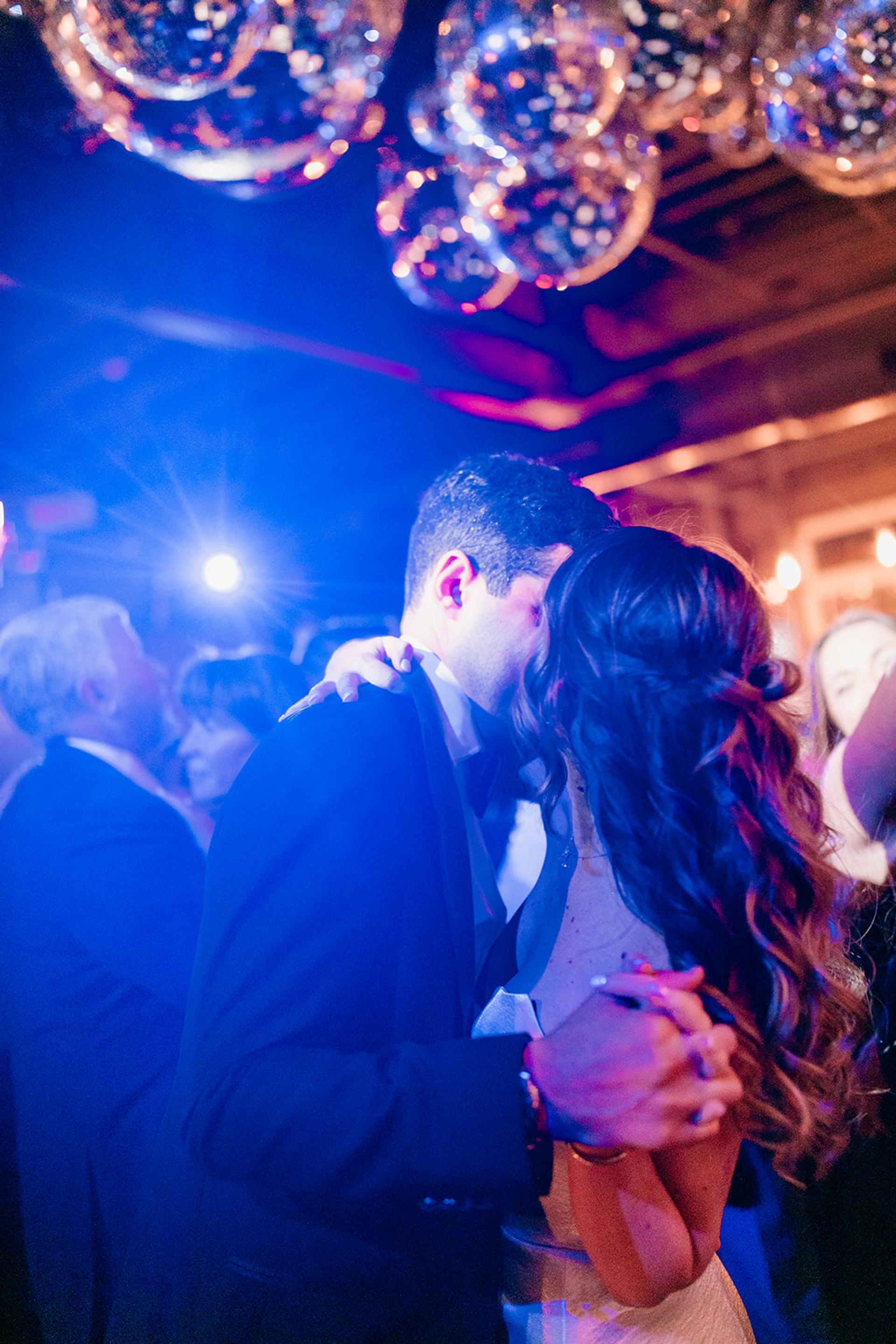 Photo of couple dancing under disco balls