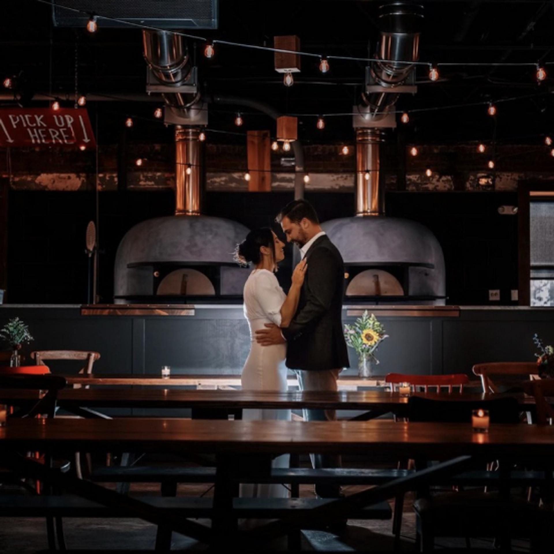 Wedding Couple in front of Second Level Pizza Ovens