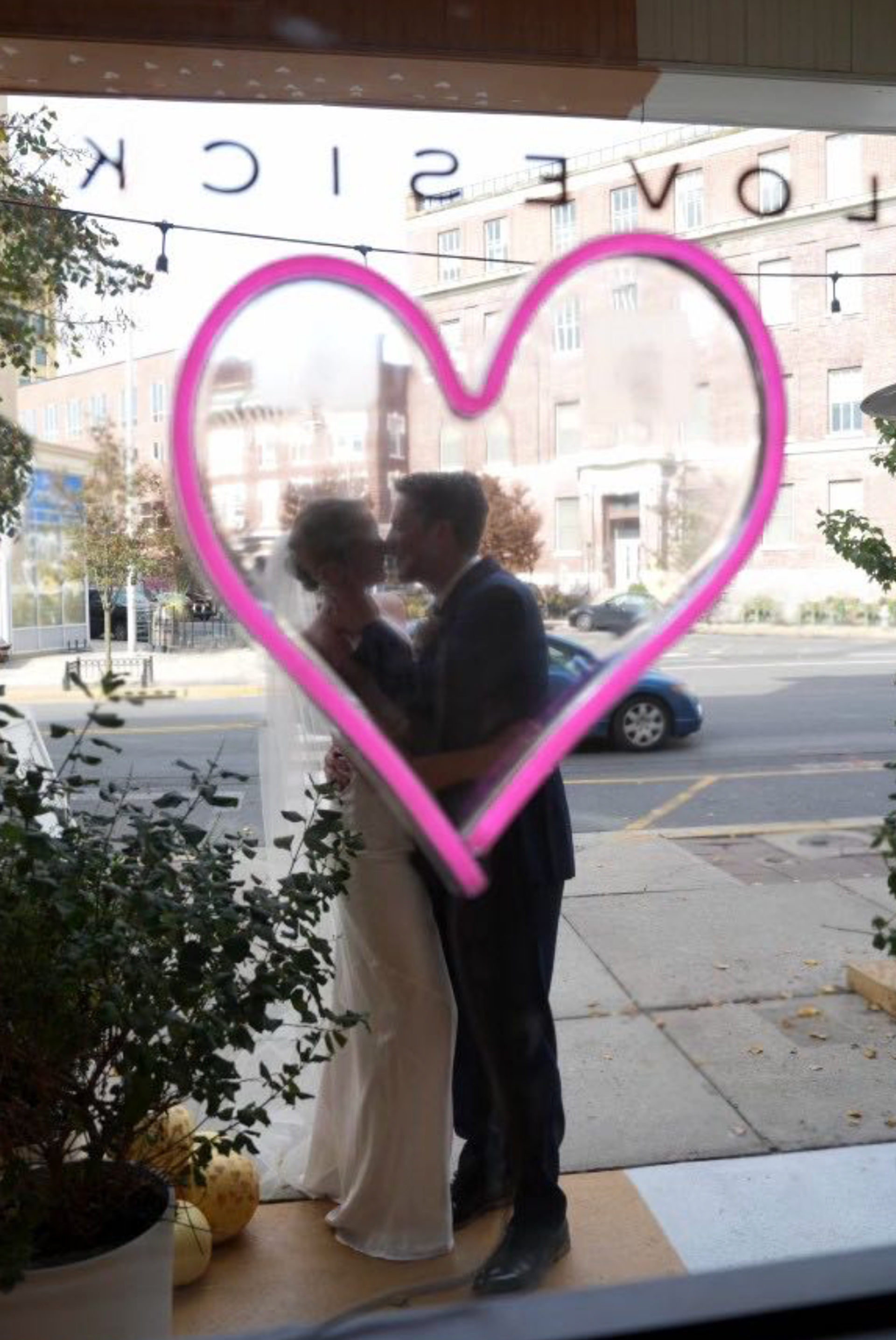 Photo of wedding couple through front door
