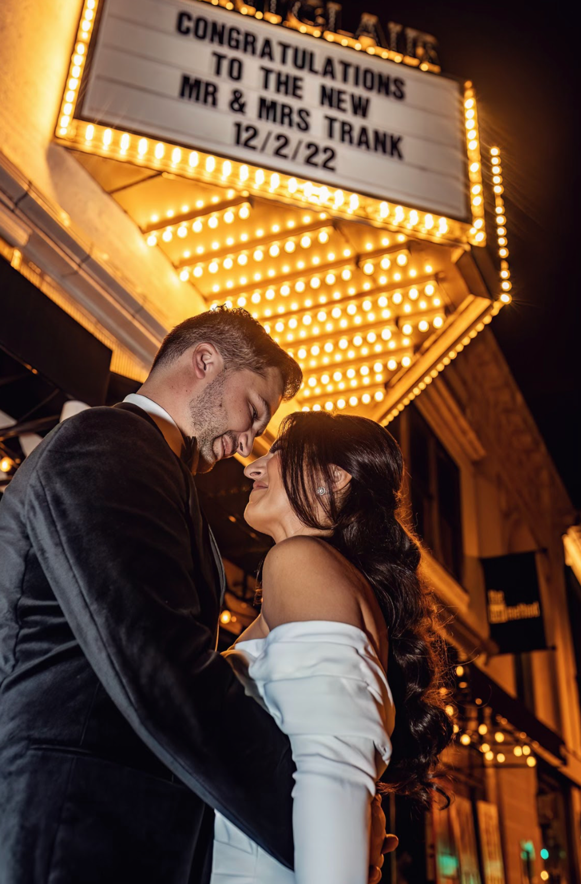 Photo of wedding couple under custom Marquee