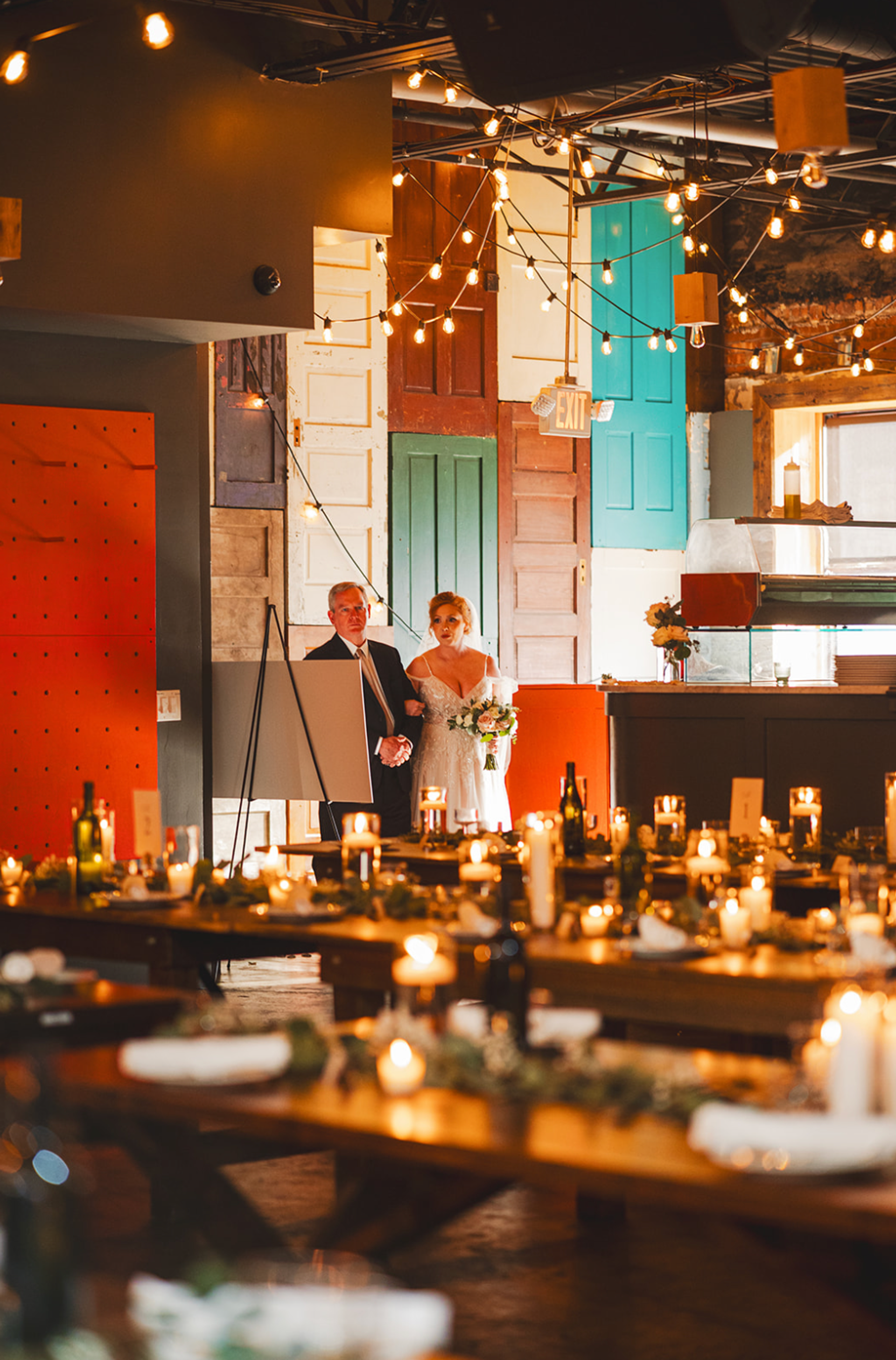 Photo of bride being walked down aisle on second level