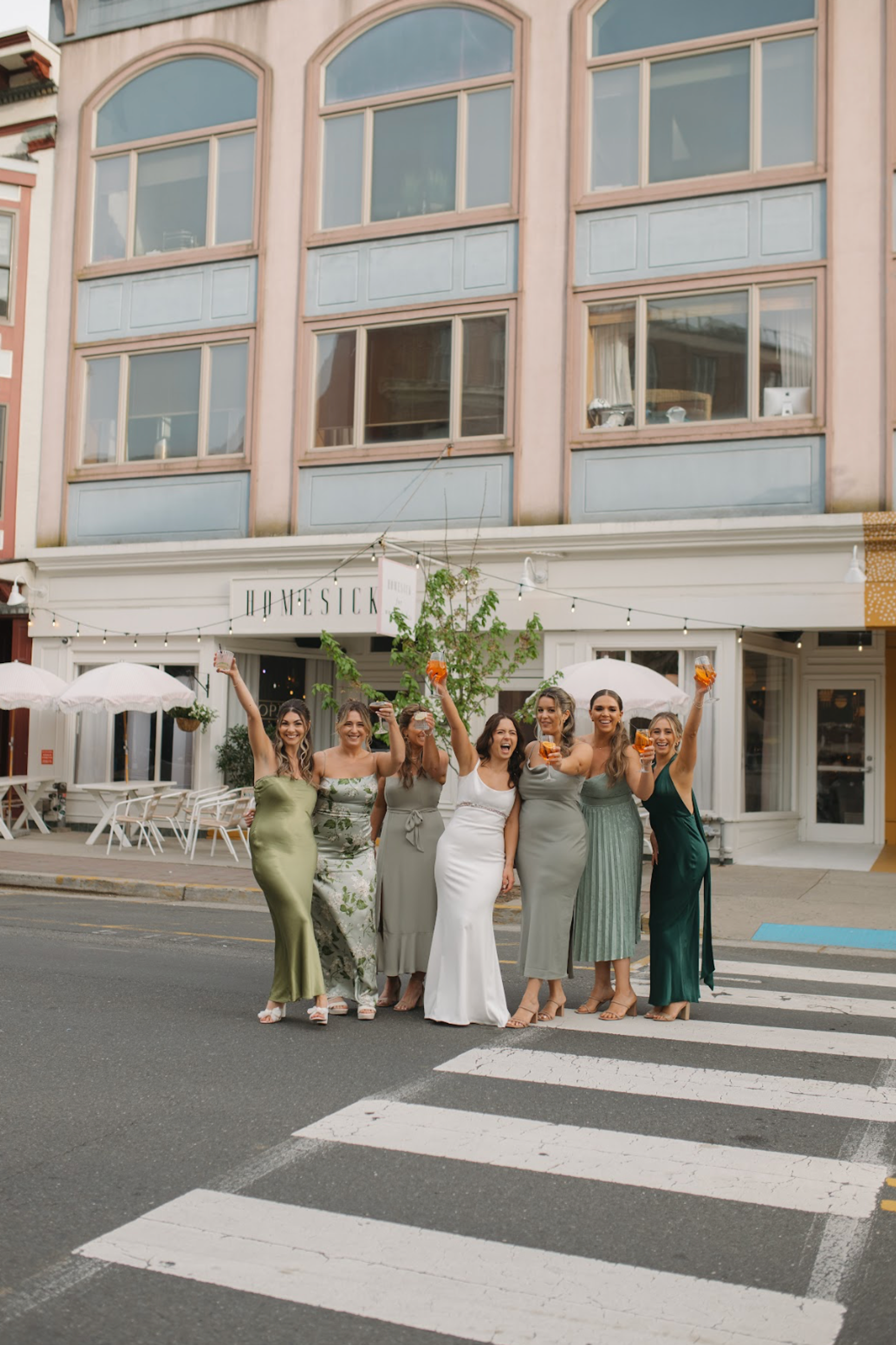 Photo of bridesmaids in front of Homesick Facade