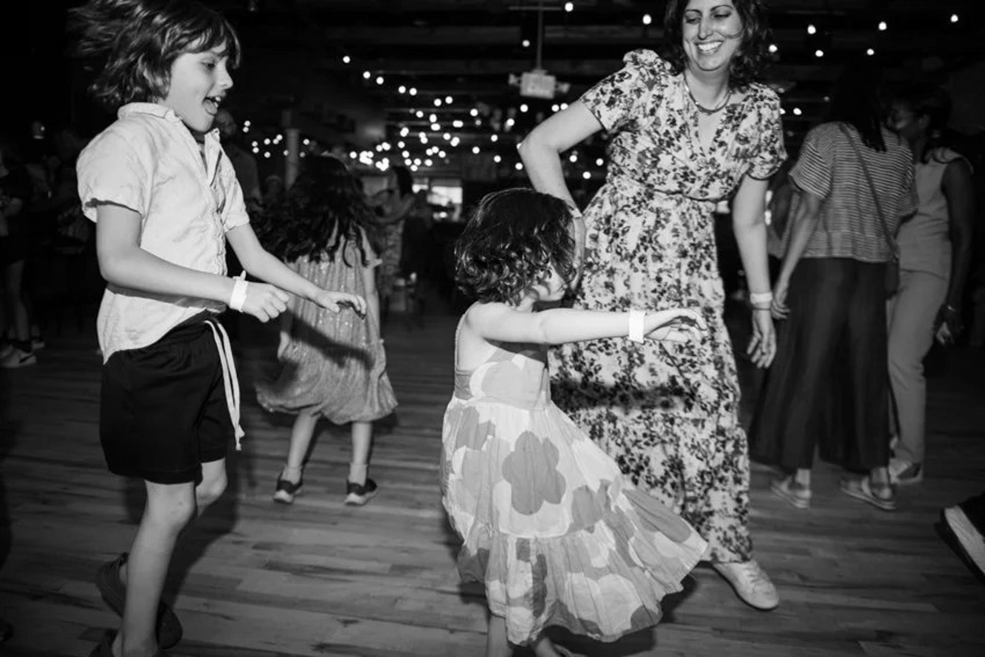 Phot of Mom and kids dancing