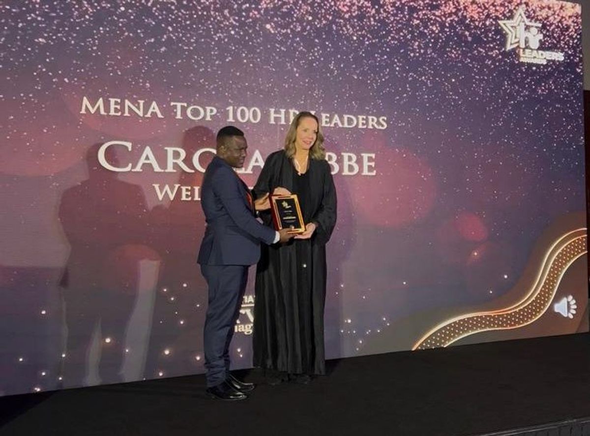 Carola Tibbe being handed the award commemorating her place as one of MENA’s Top 100 HR Leaders