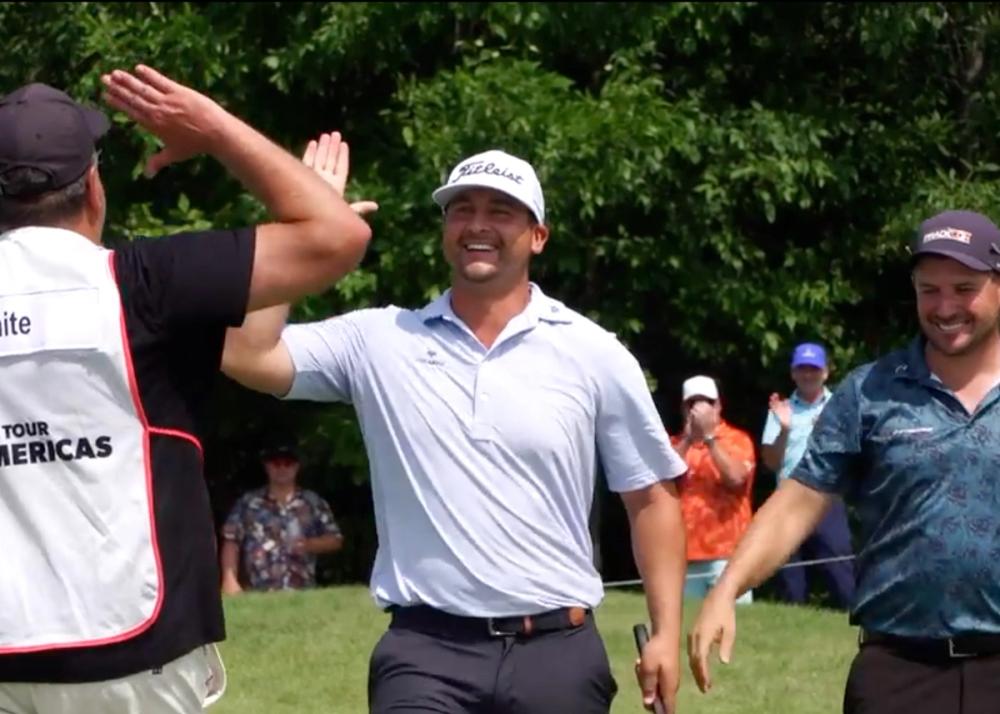 Brett White celebrates with his caddy after draining a 63-foot eagle putt for 59 on PGA TOUR Americas