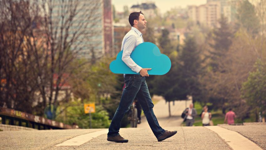 man carrying a cardboard cutout of a cloud