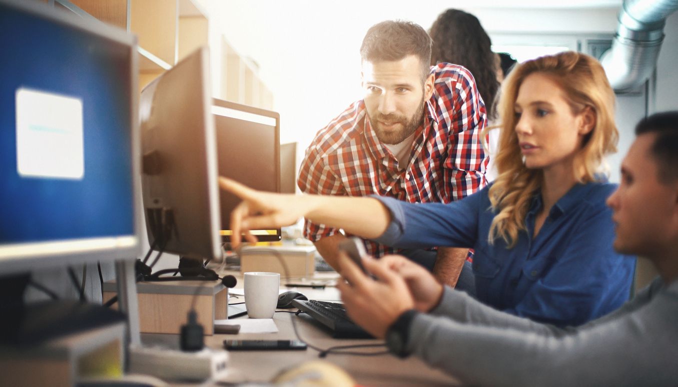 Office workers looking at a project in progress