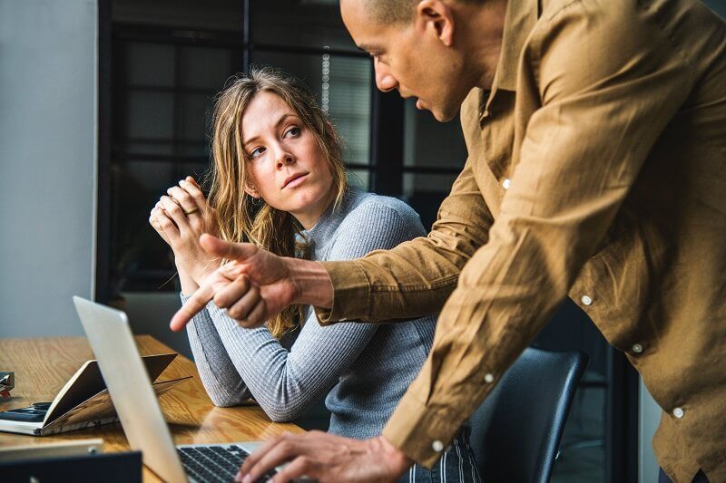 Two employees at work benefiting from their company integrating knowledge management with eLearning