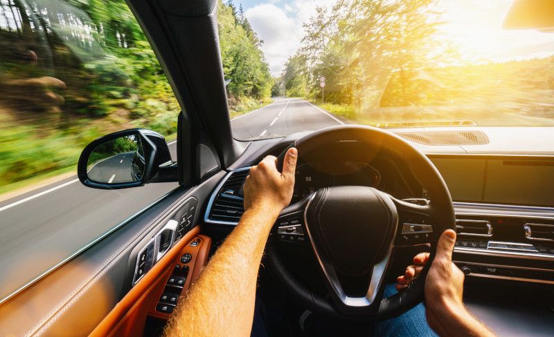 A car depicted driving on the right-hand side of the road