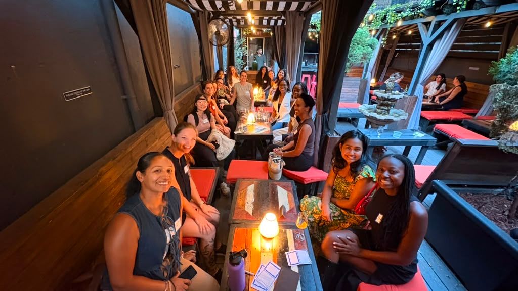 Members talking around a table at an Audacious AF social