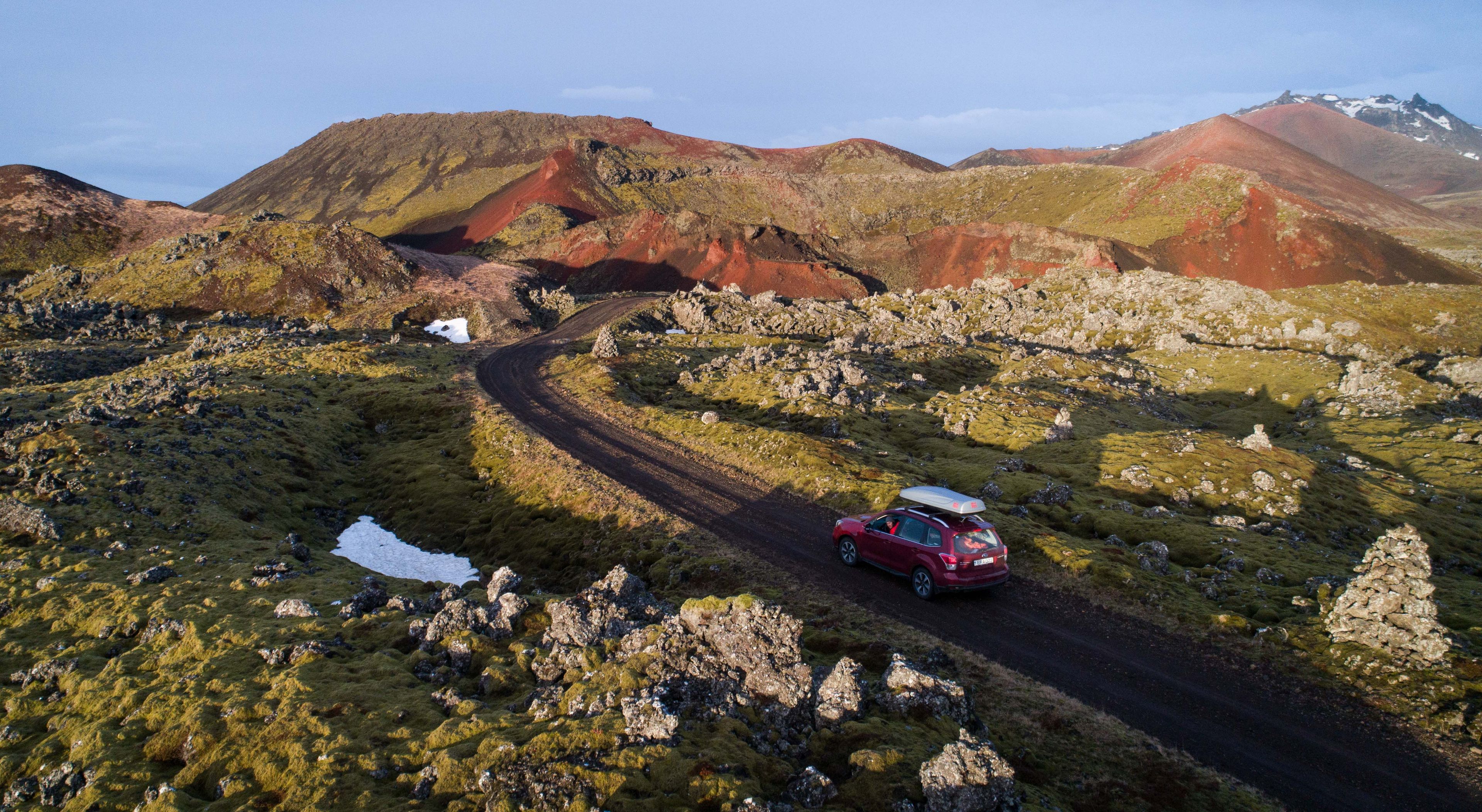 A subaru Forester SUV driving a F-road in a rugged terrain in Iceland 