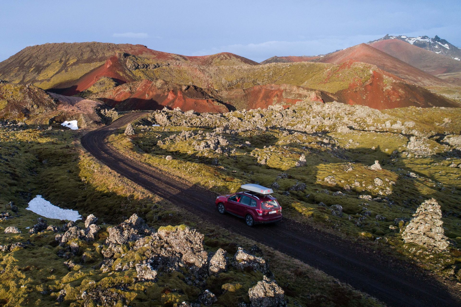 A subaru Forester SUV driving a F-road in a rugged terrain in Iceland 