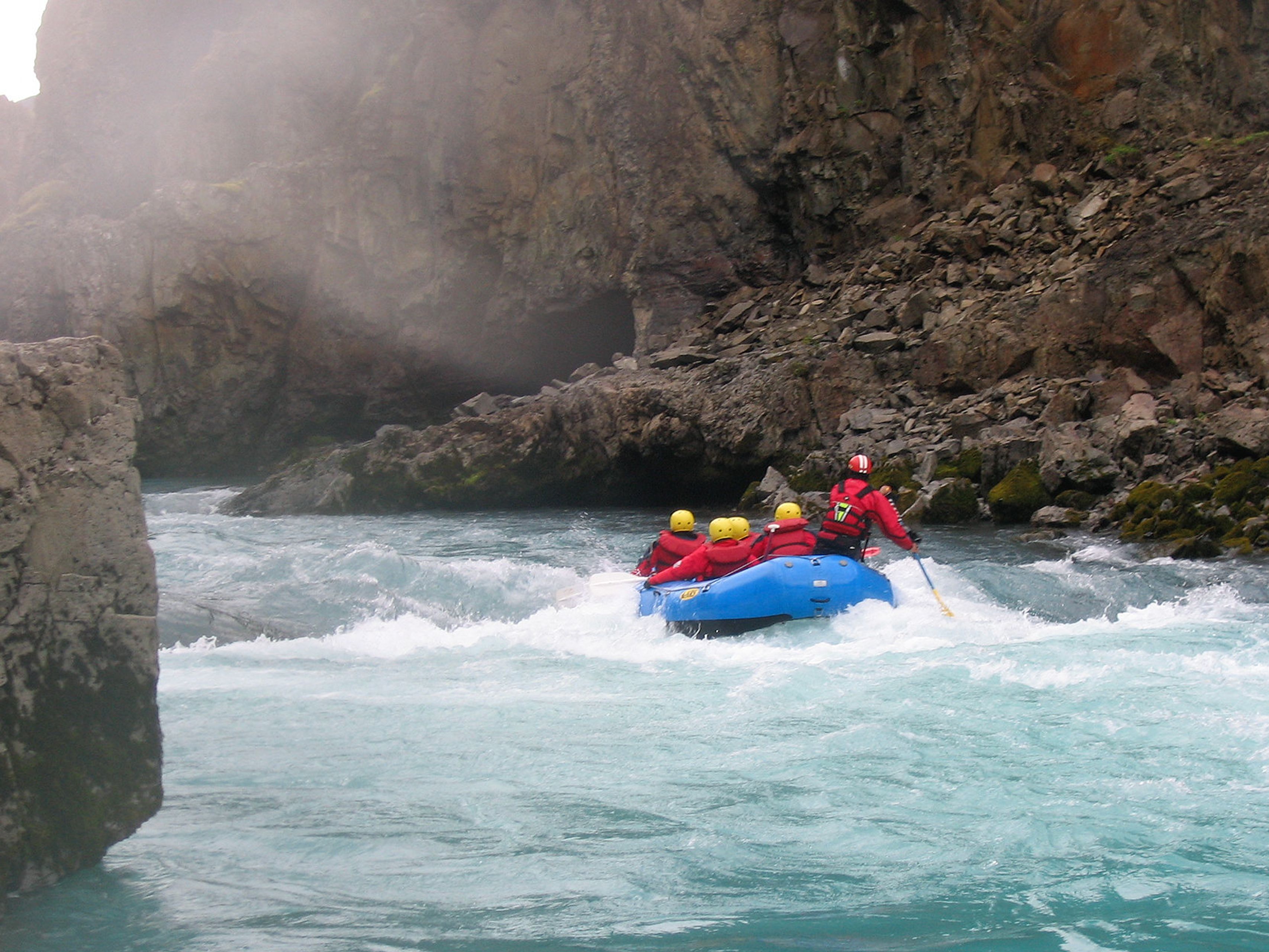 Group of people river rafting in Iceland