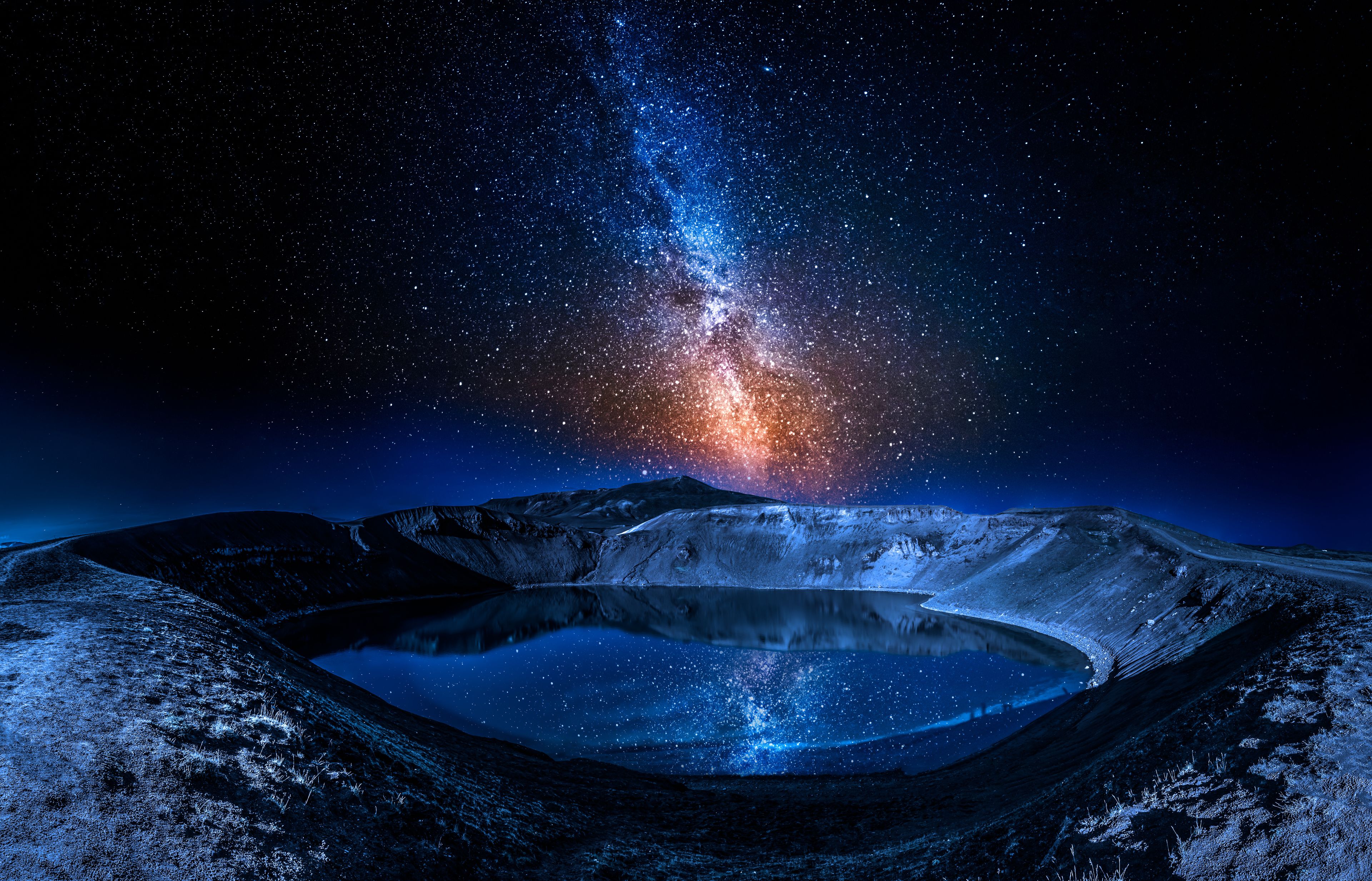 Lake in the volcano crater at night with stars, Iceland