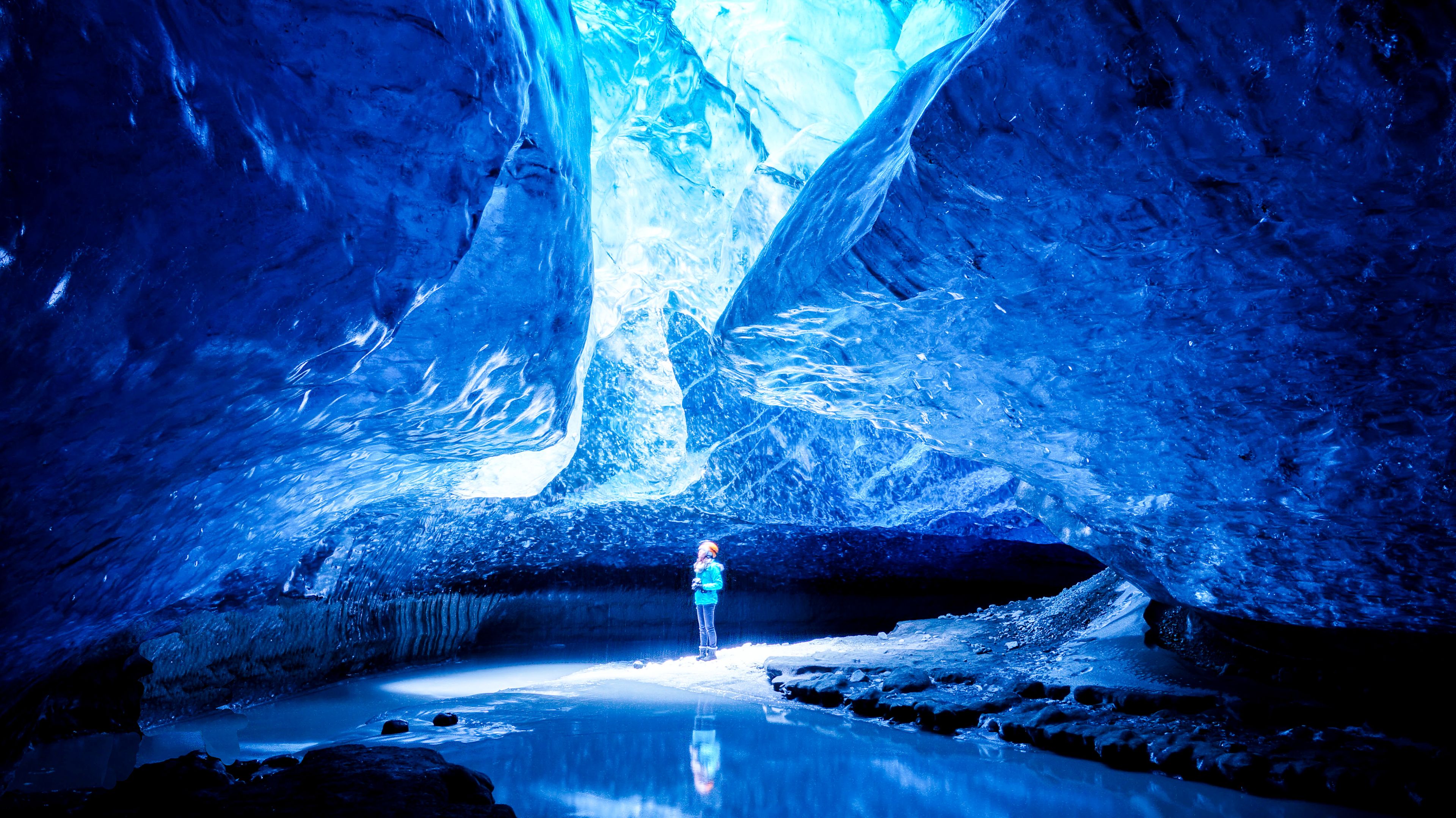 Girl in the middle of an ice cave in Iceland