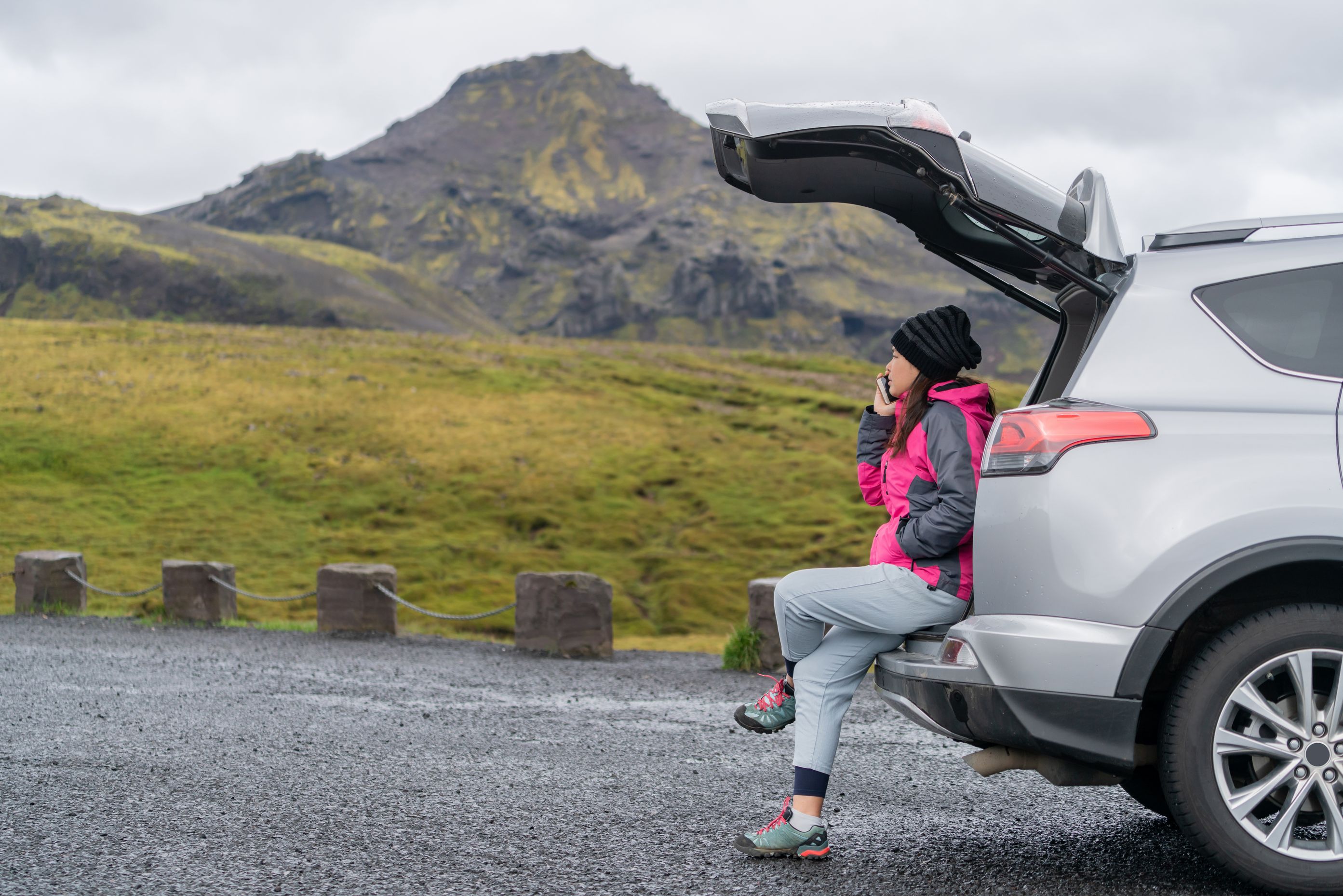 Car rental in Iceland with a person and a picturesque landscape in the background
