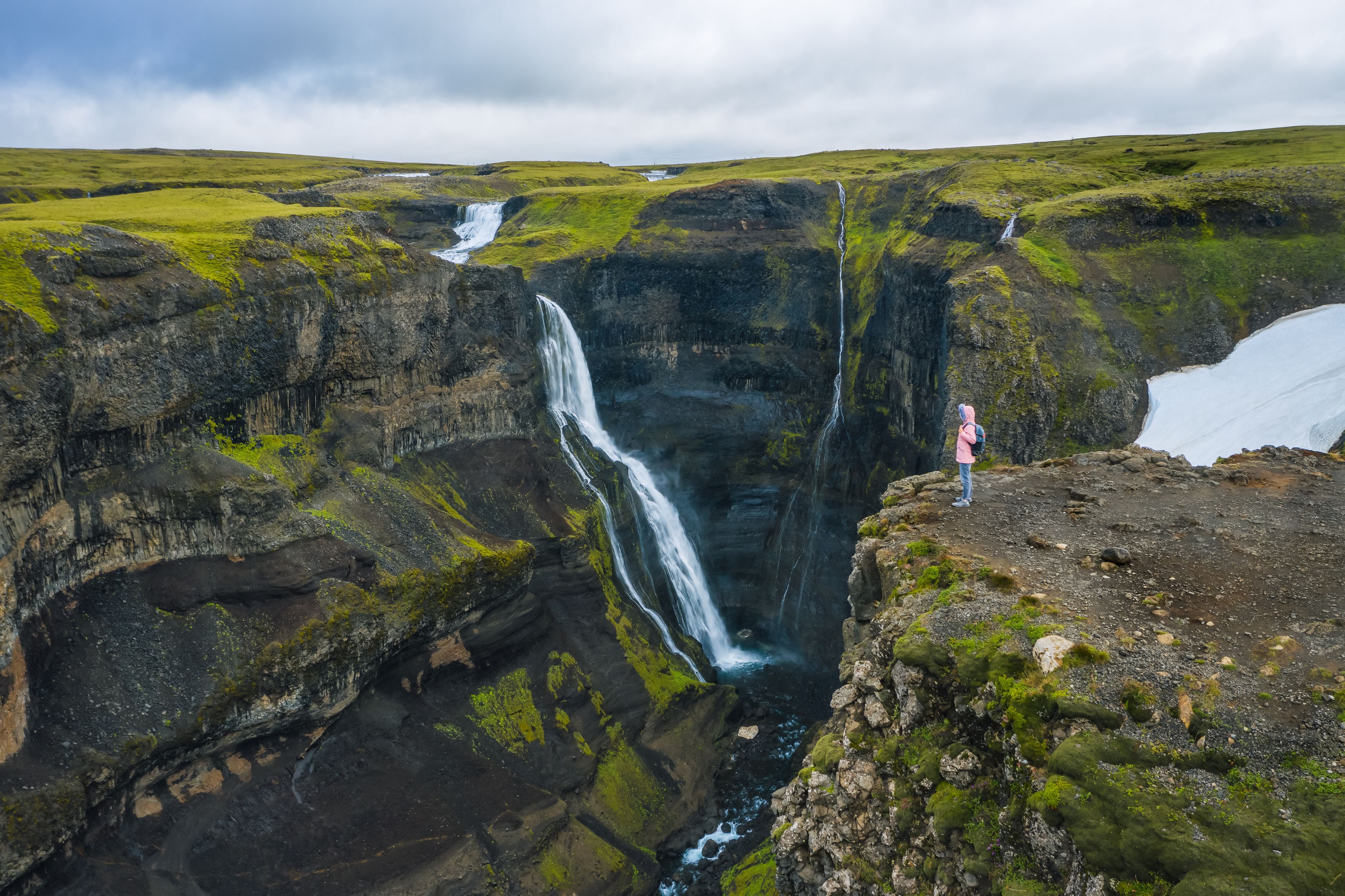 Hiker admiring Granni waterfall from the viewpoint