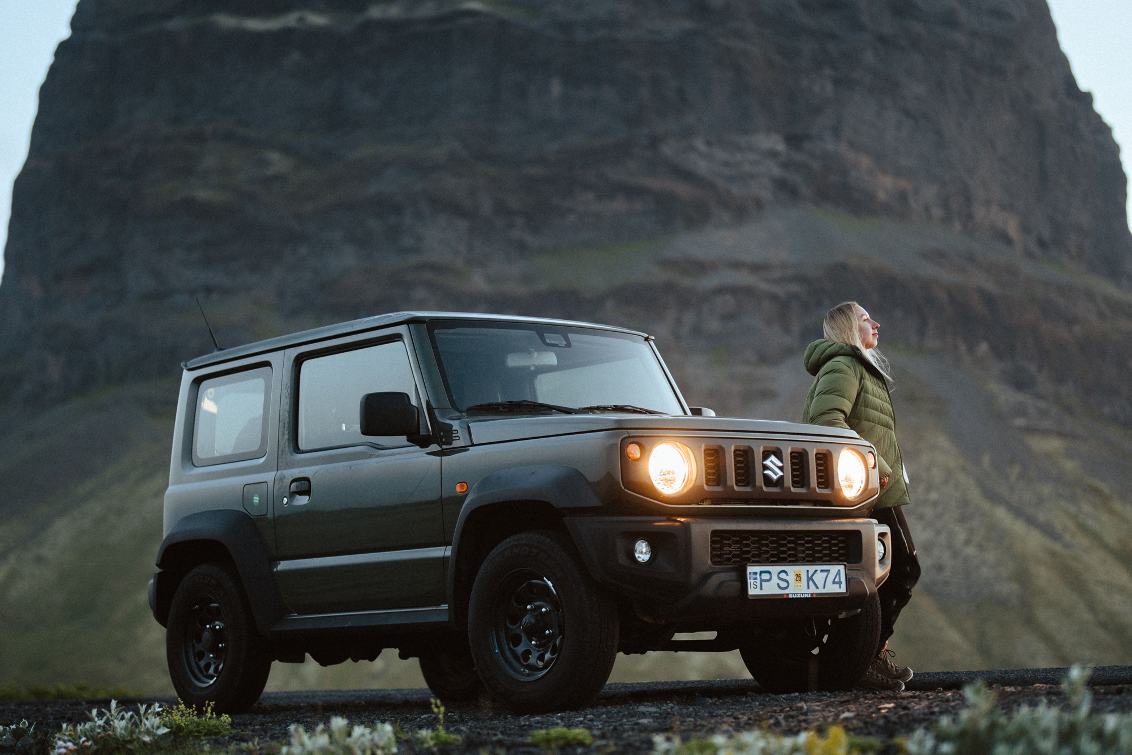 A woman Iceland in September, enjoying iceland nature her her 4x4 rental car
