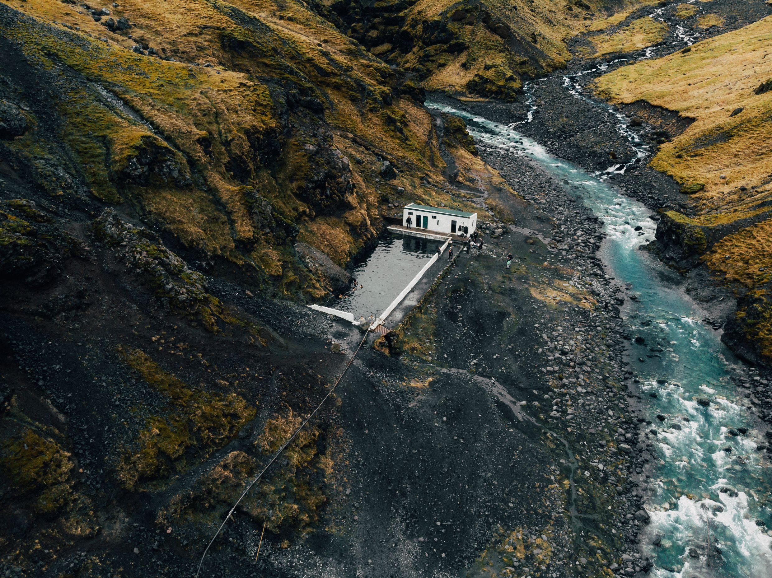 Aerial view of Iceland's hot springs with steam rising from the pools