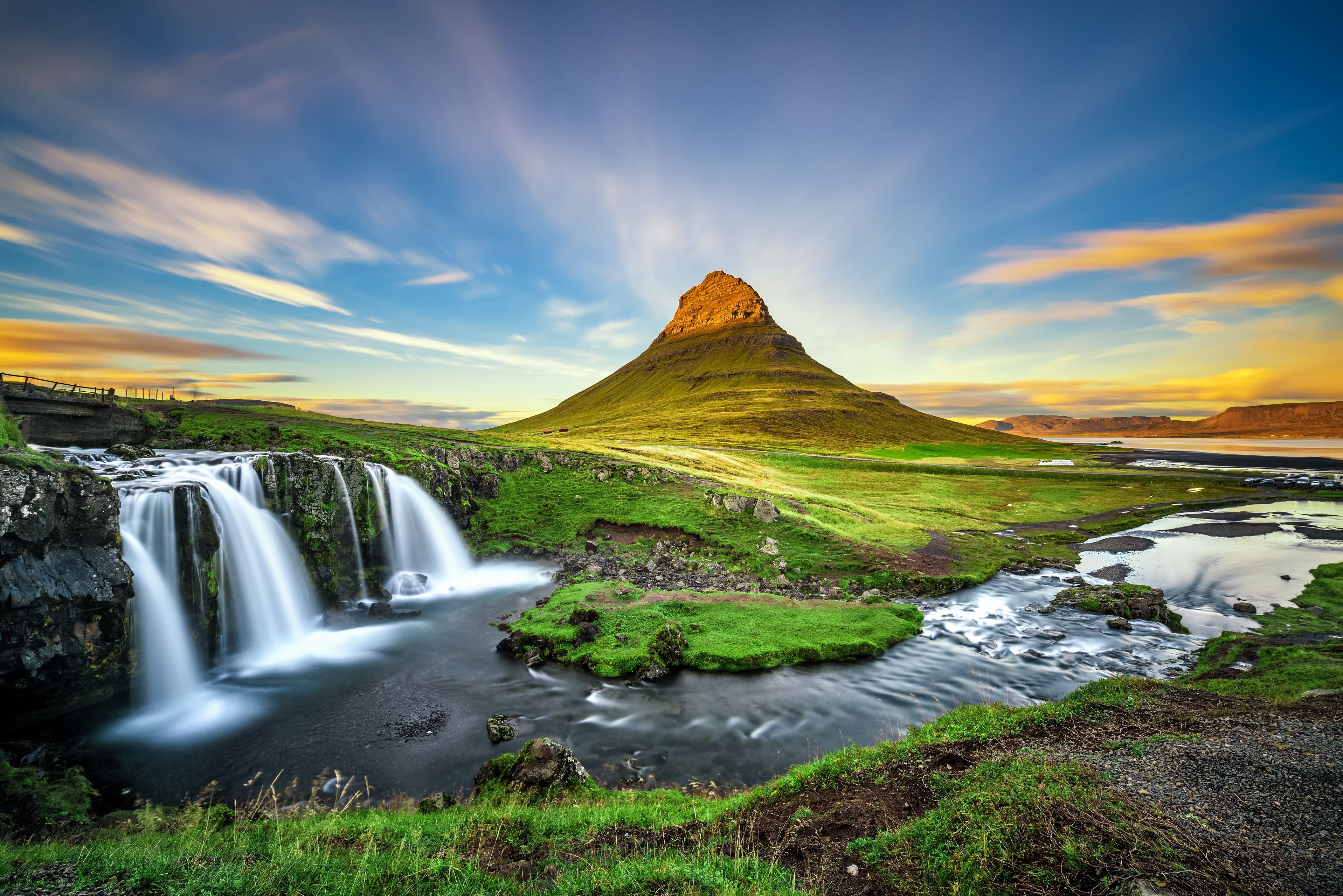 Sunset over Kirkjufellsfoss Waterfall and Kirkjufell mountain in Iceland