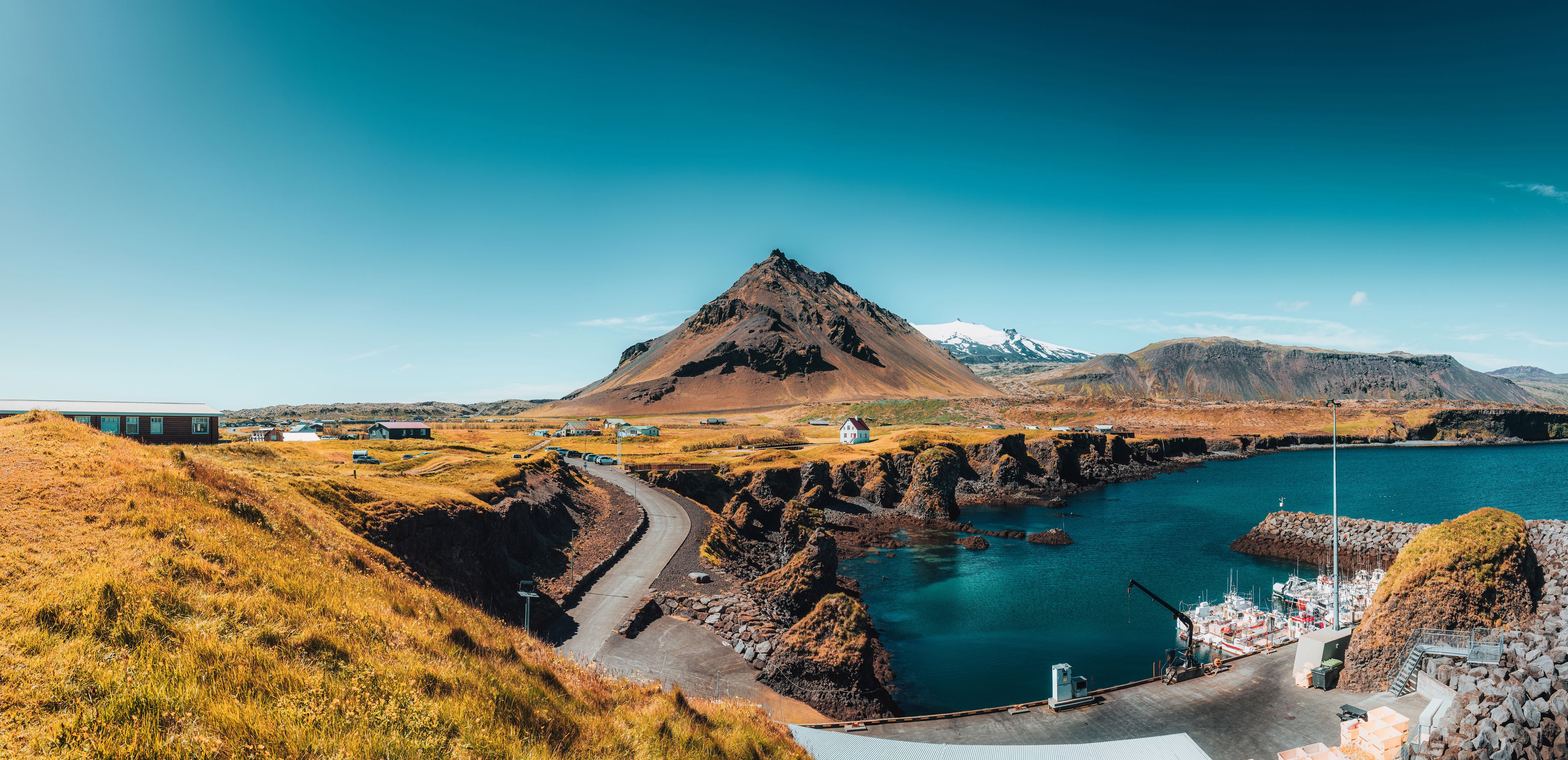 landscape with a small seaport with mountains in the background