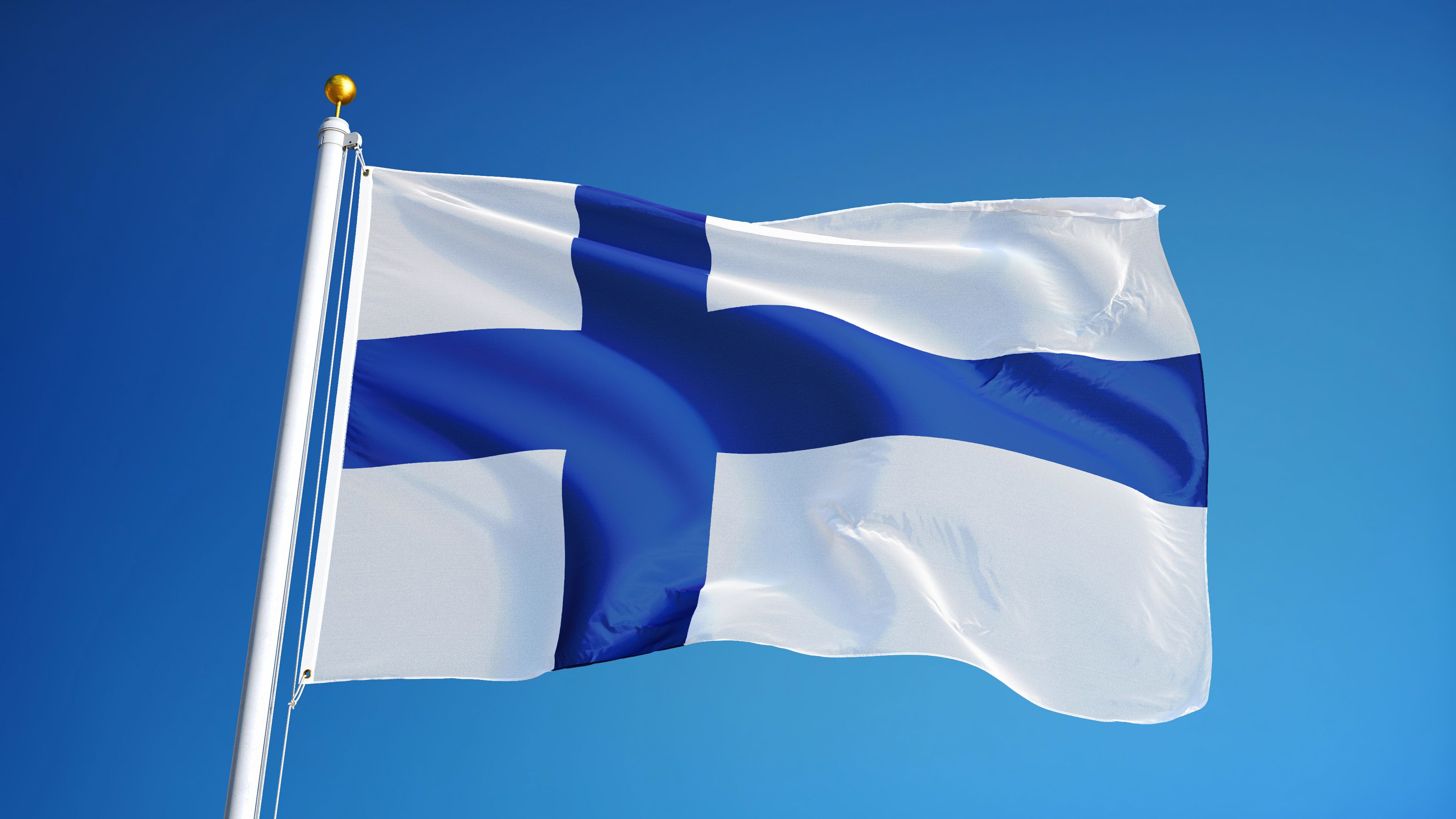 Finland flag waving against clean blue sky