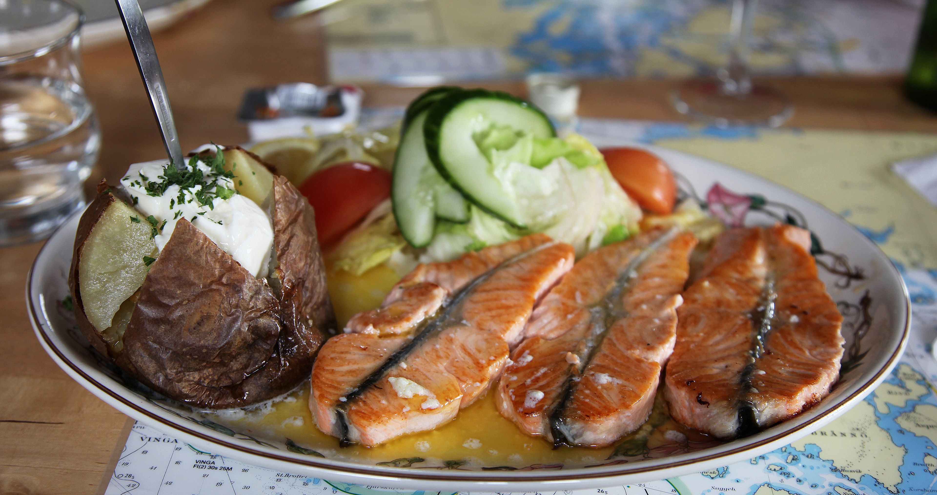 dish with salmon steak, baked potatoes and vegetables at the restaurant 