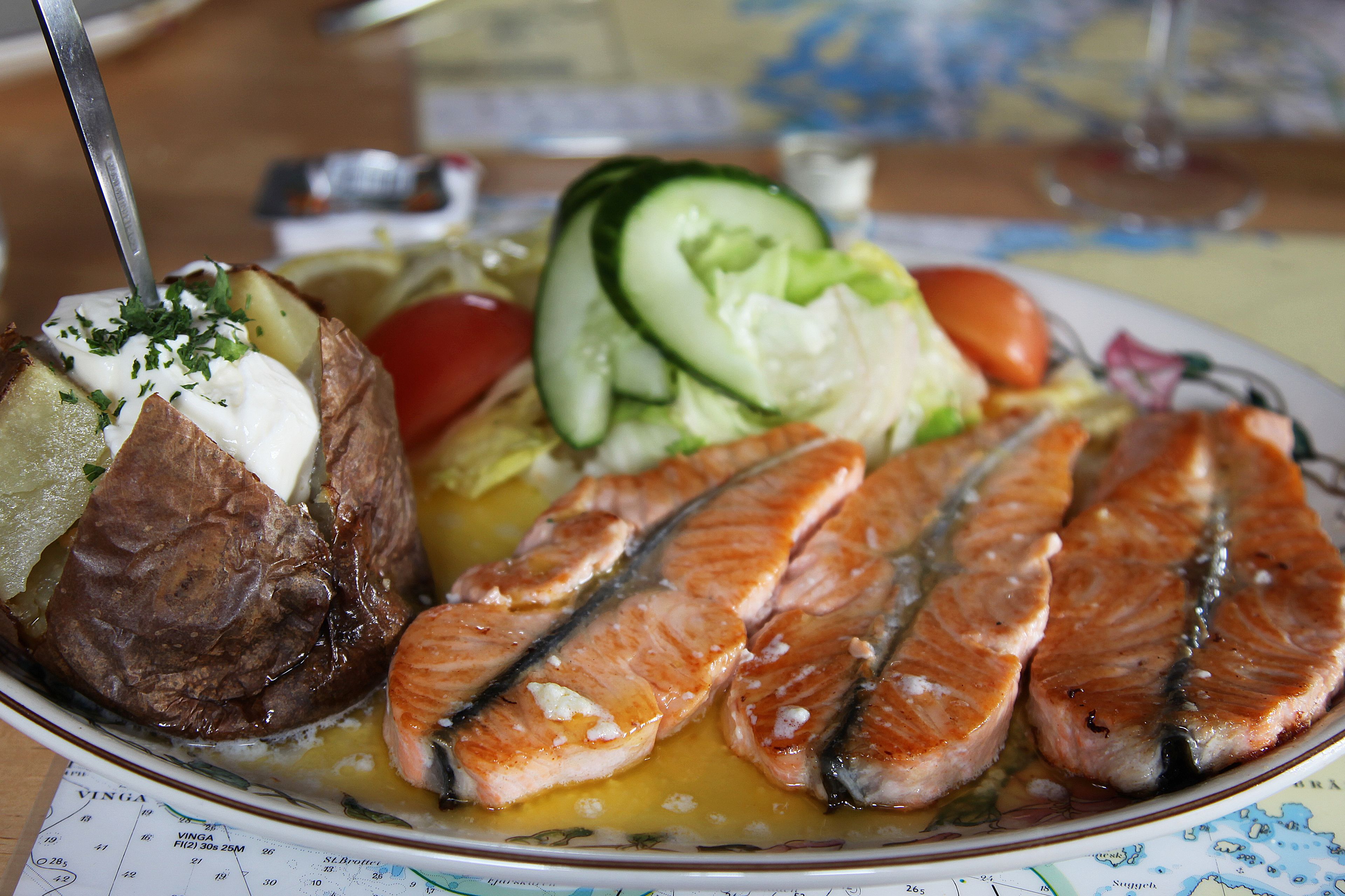 dish with salmon steak, baked potatoes and vegetables at the restaurant 