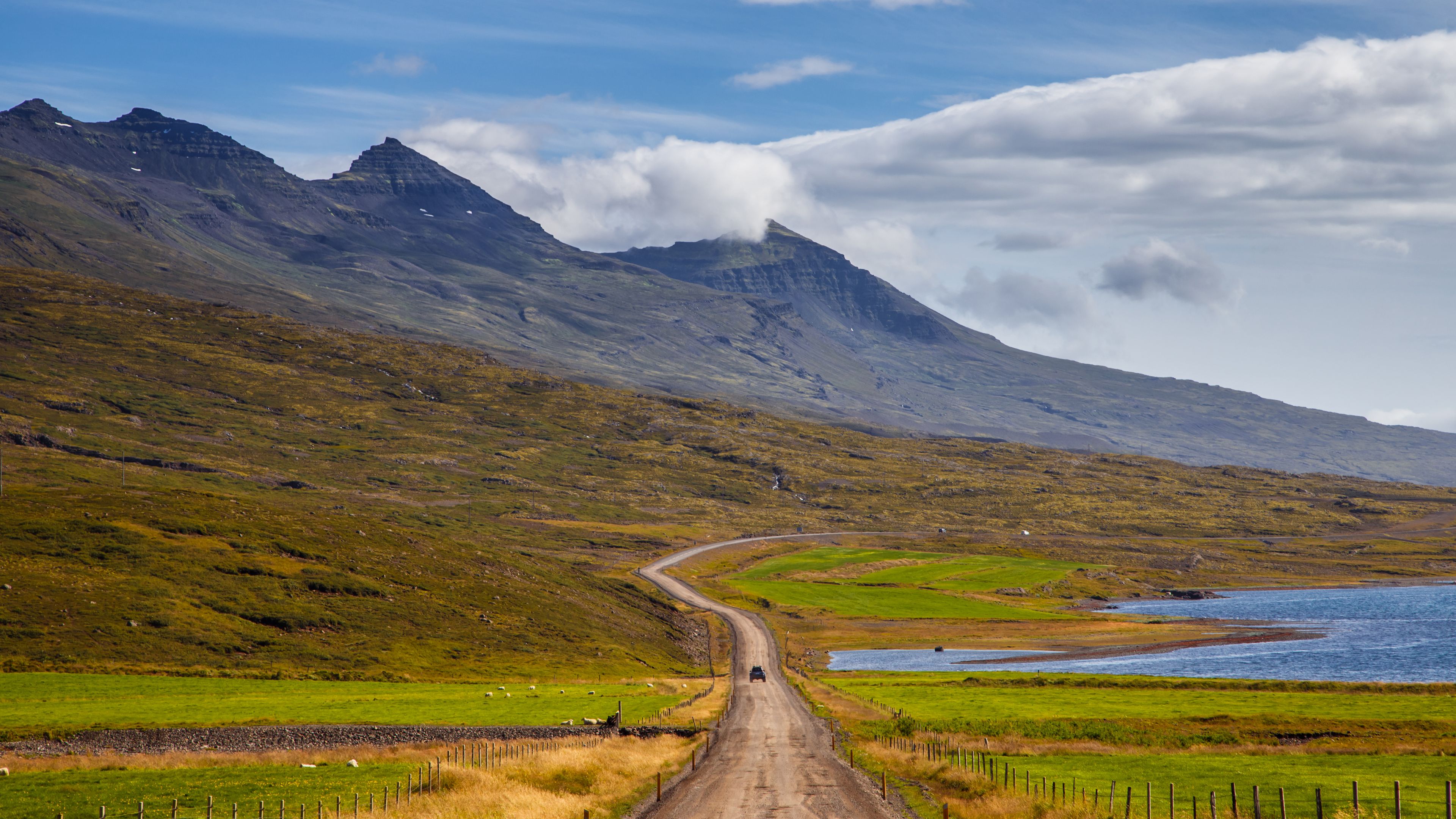 Road on a east of Iceland on mount background at sunny day