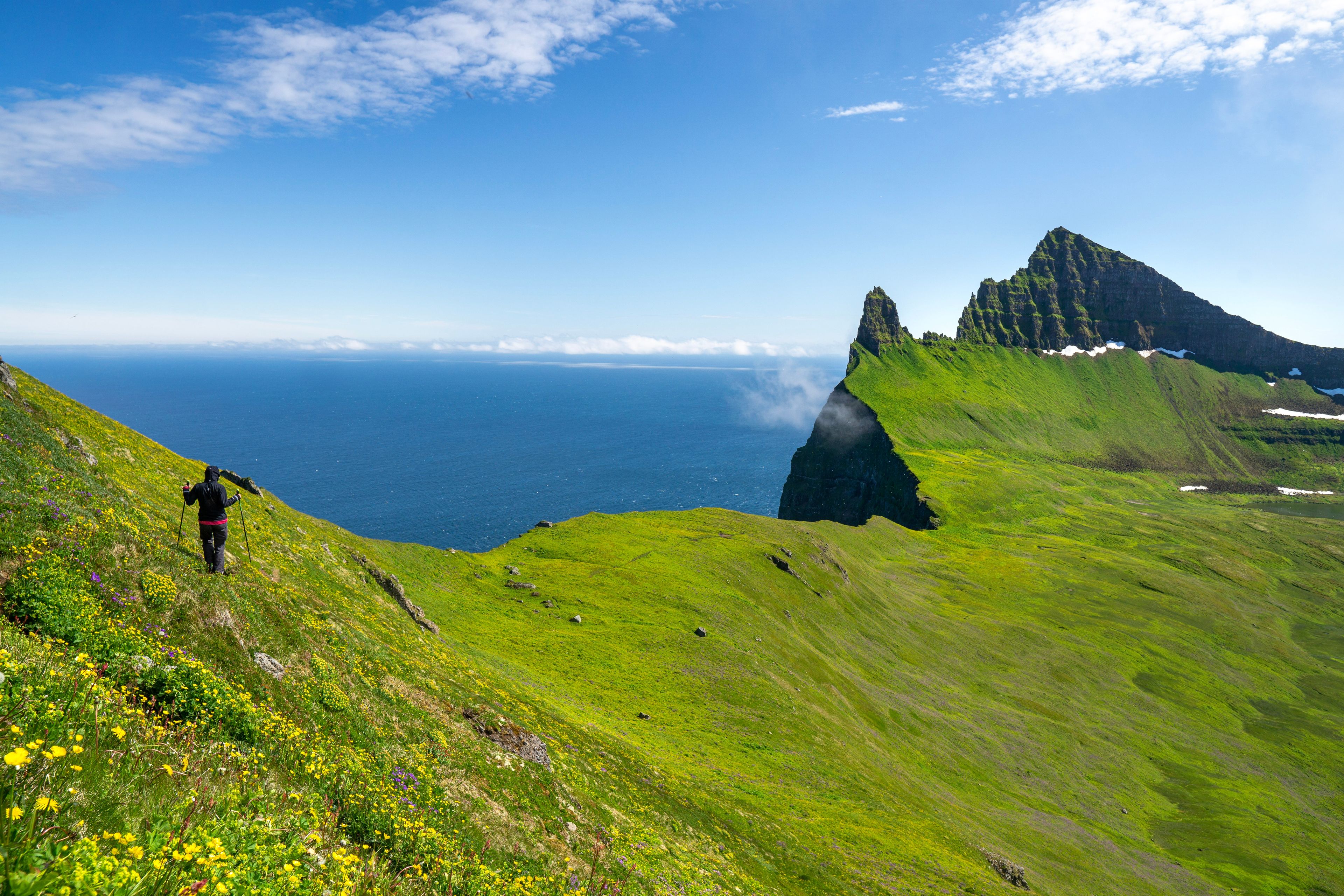 A girl hiking over Hornbjarg cliffs, Hornstrandir peninsula, Westfjords, Iceland