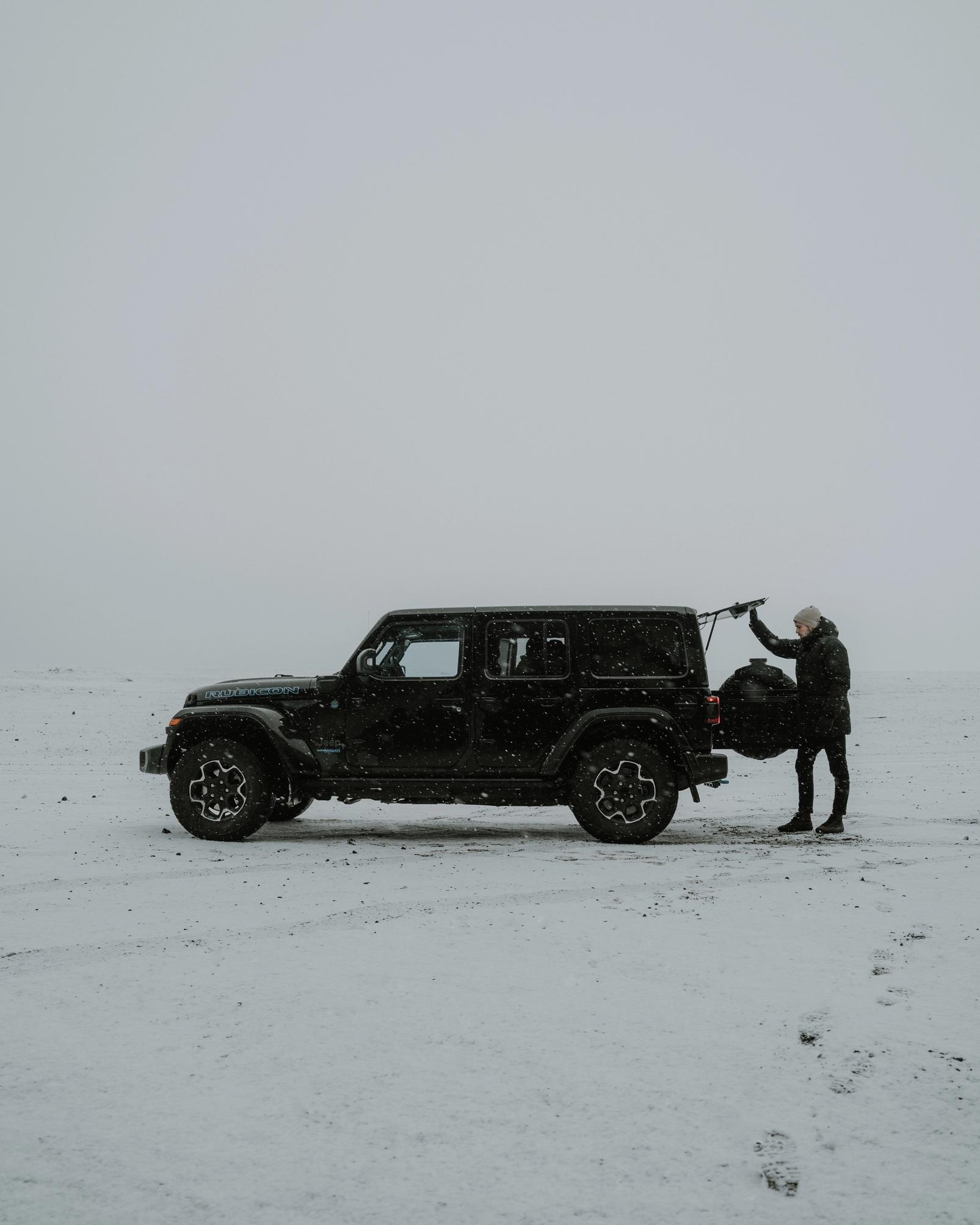 view on a black Iceland jeep rental parked in the snow in Iceland.