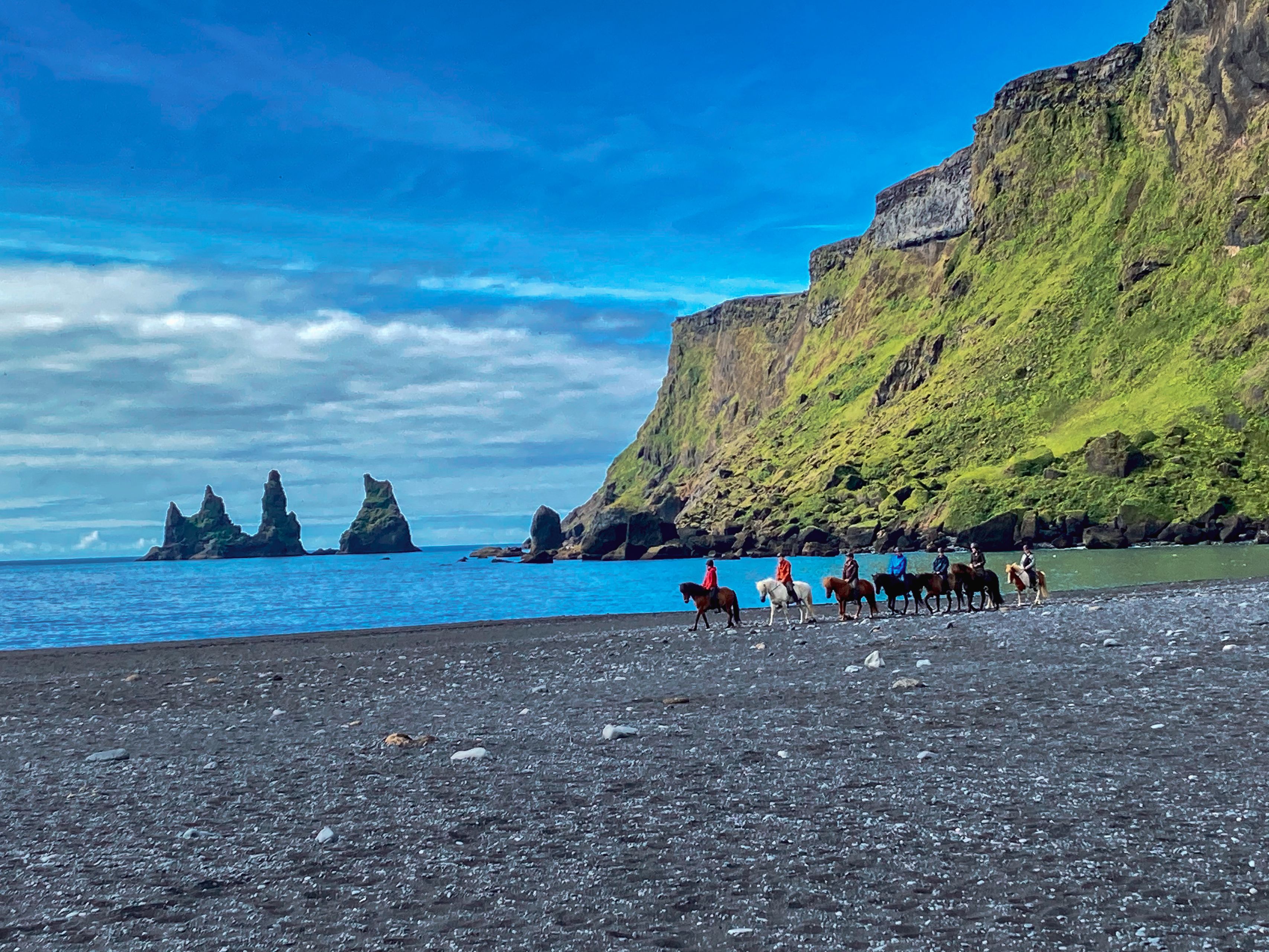 People horseback riding in Reynisfjara