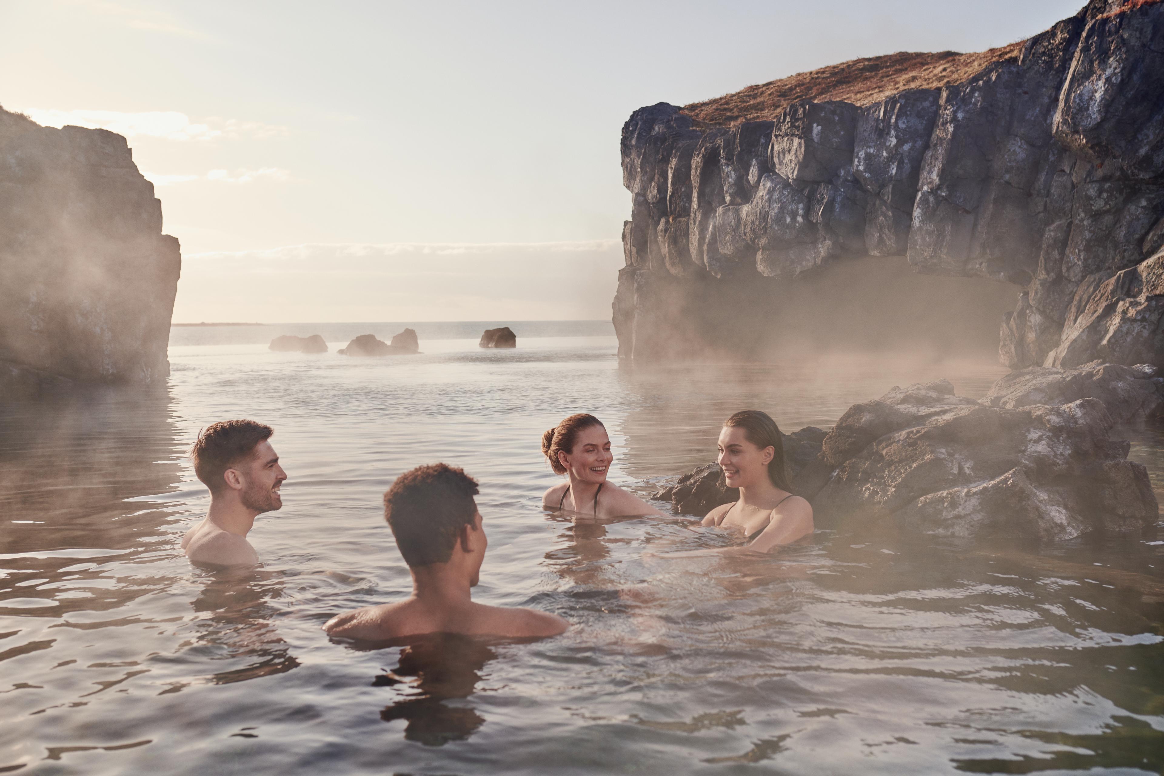 Hot springs in iceland: Sky Lagoon, a Geothermal pool with warm waters in Reykjavik Iceland, the perfect place to see midnight sun.