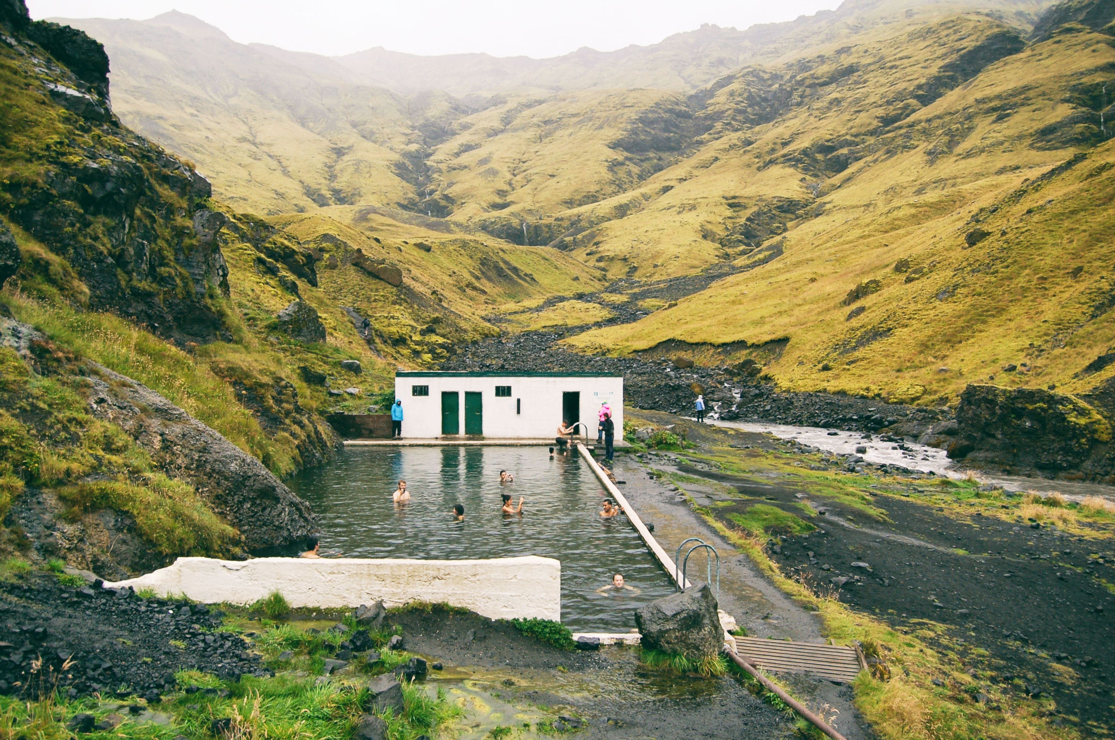 People bathing in Seljavallalaug pool