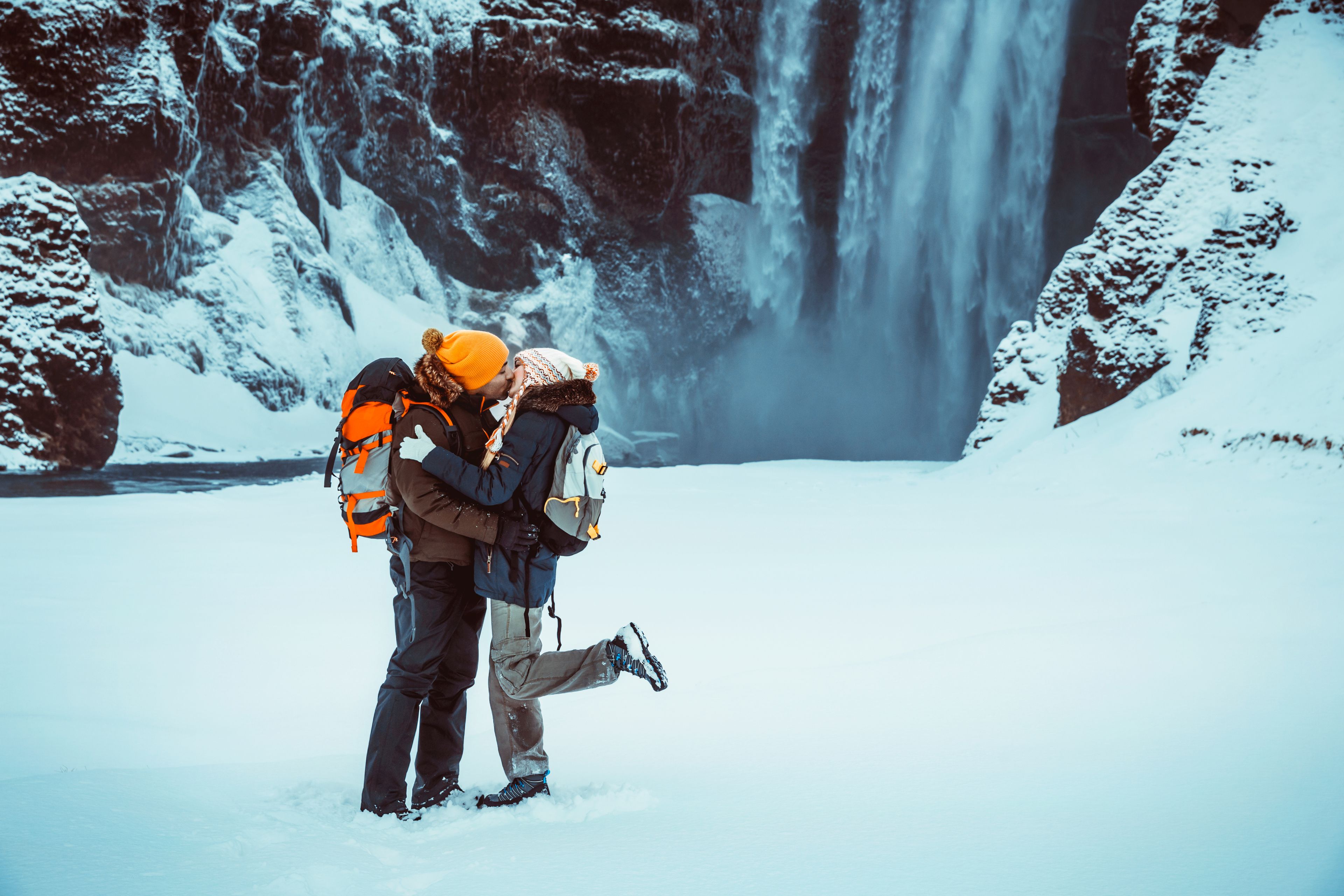 Honeymoon winter vacation with a waterfall behind