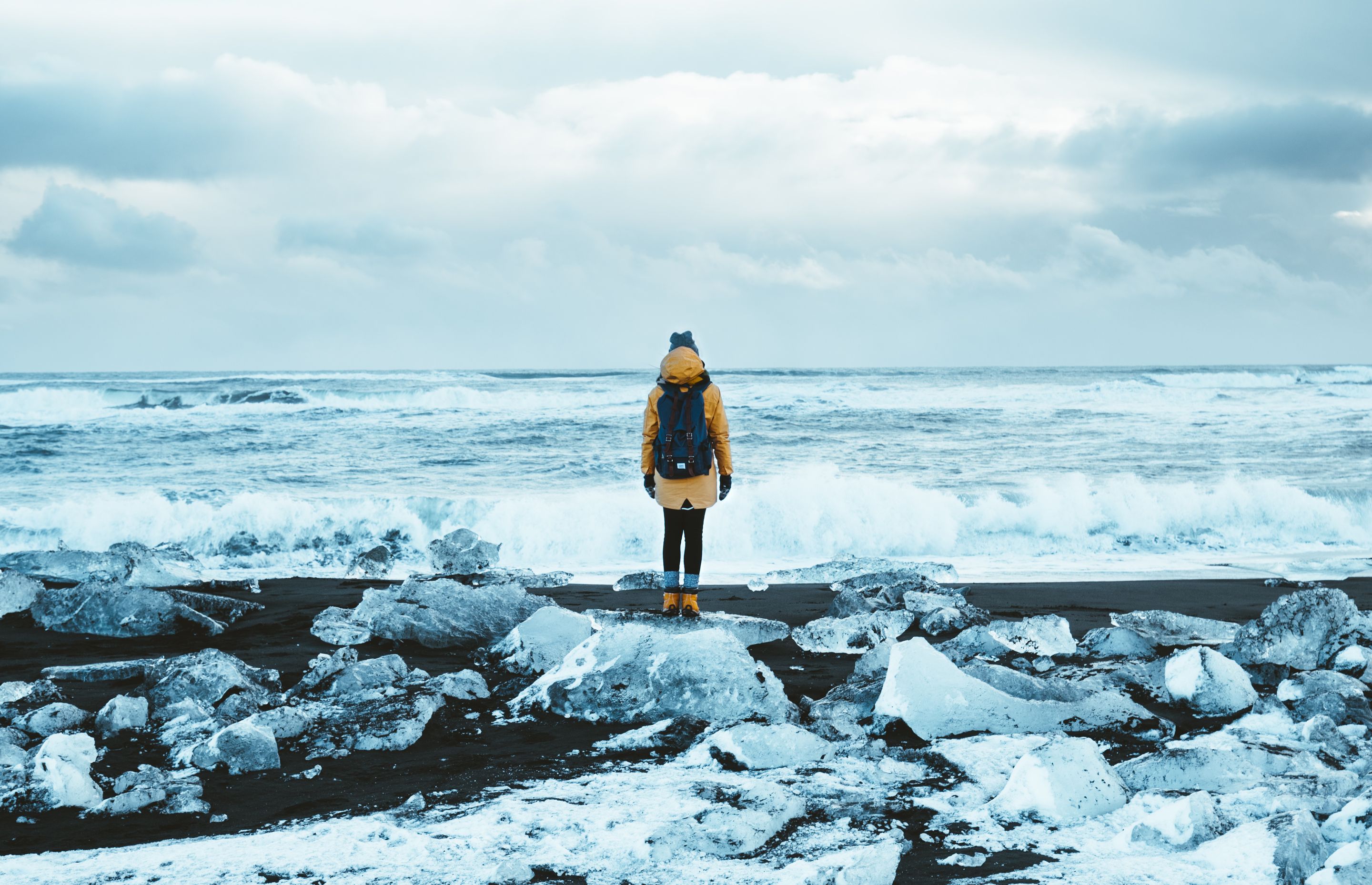 woman from the back in winter admiring the landscape offered by the diamond beach