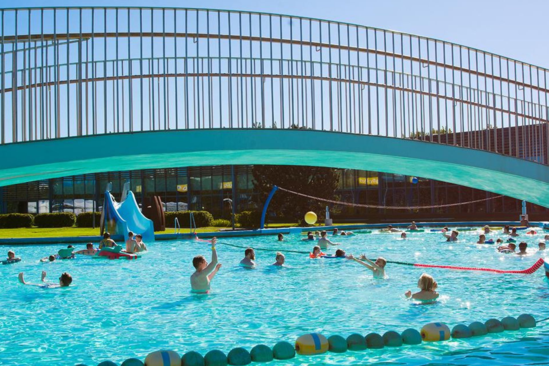 people enjoying the summer sun and the large Laugardalslaug pool, which offers a multitude of games