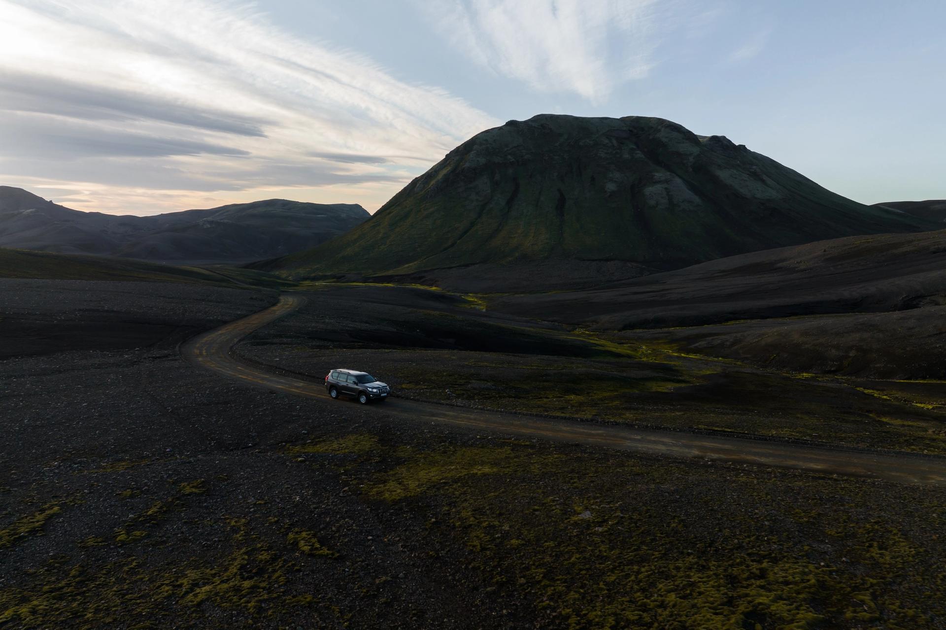 A robust Toyota Land Cruiser navigating the off-roads in Iceland's rugged terrain