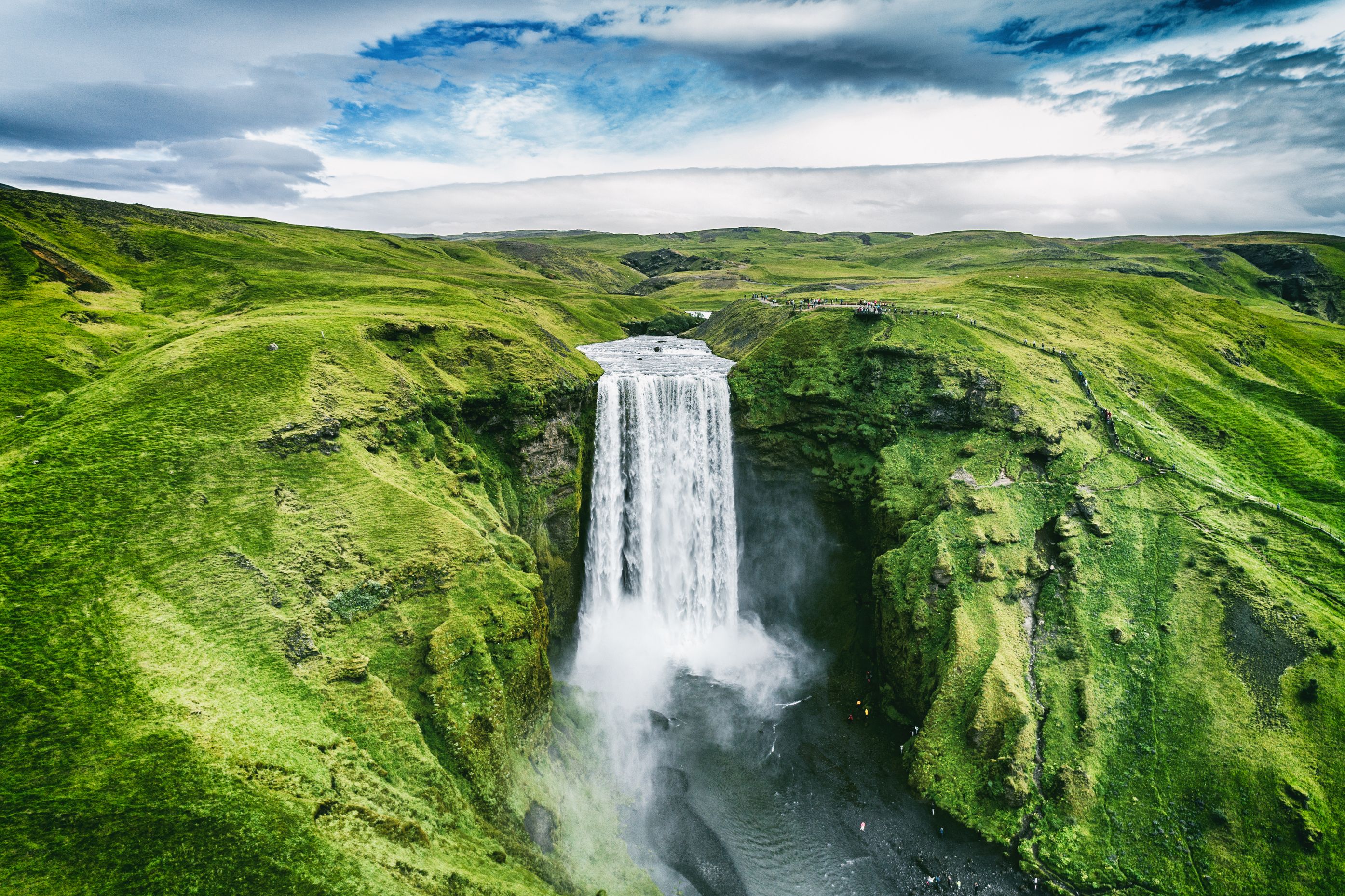 Aerial of Skógafoss Waterll surrounded by green