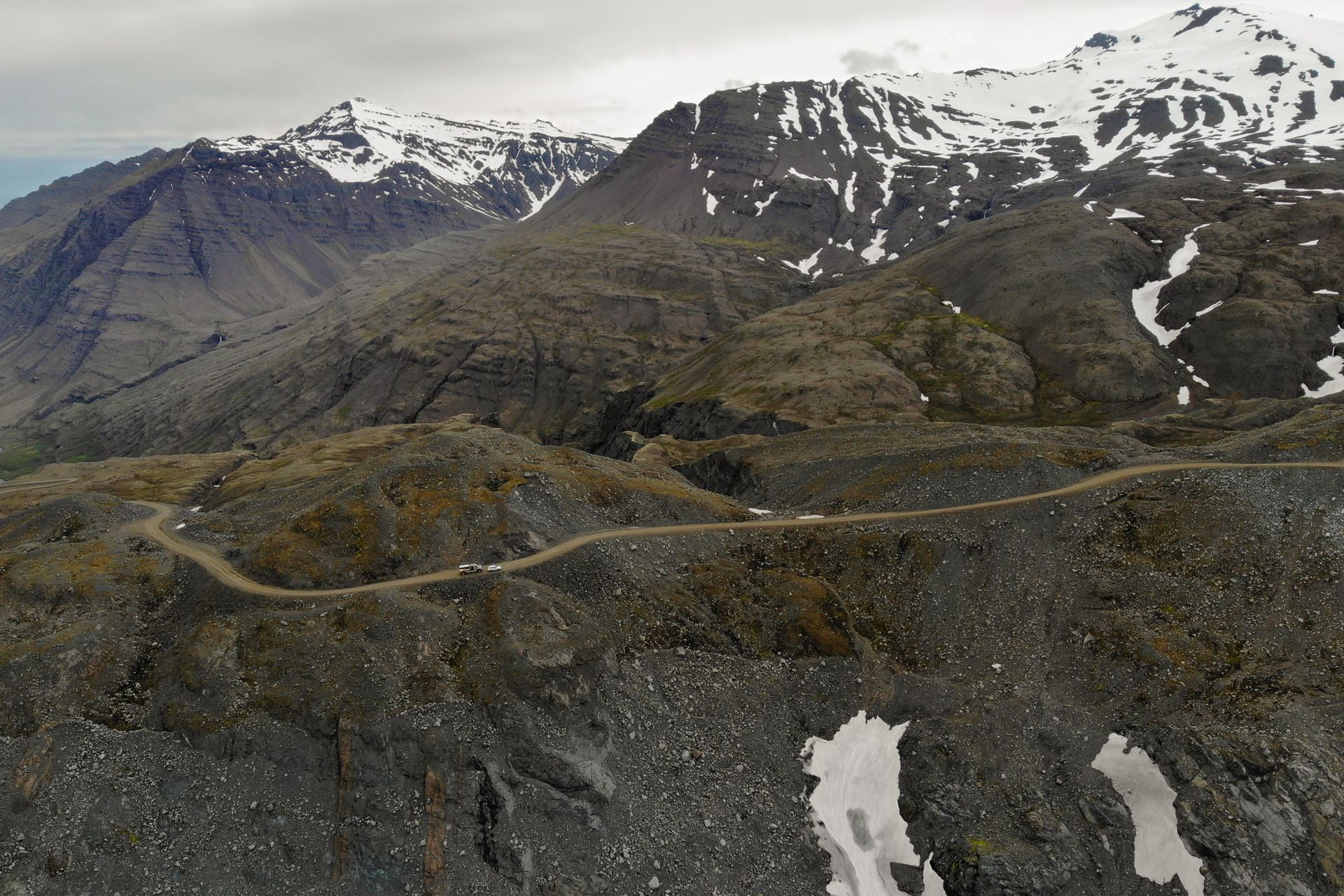 Aerial view of mountain road F985 leading to Joklasel and the Skalafellsjokull glacier, part of Vatnajökull National Park, Iceland. Panoramic landscape shot by drone camera.