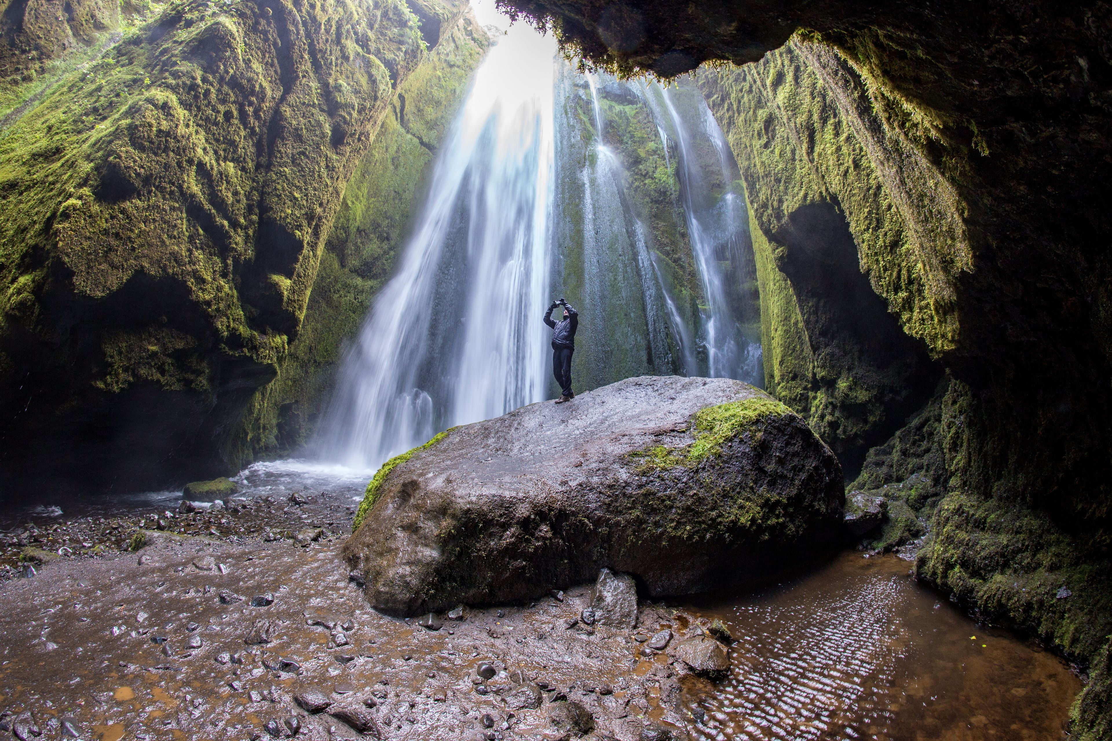 Man inside the canyon of Gljúfrabúi